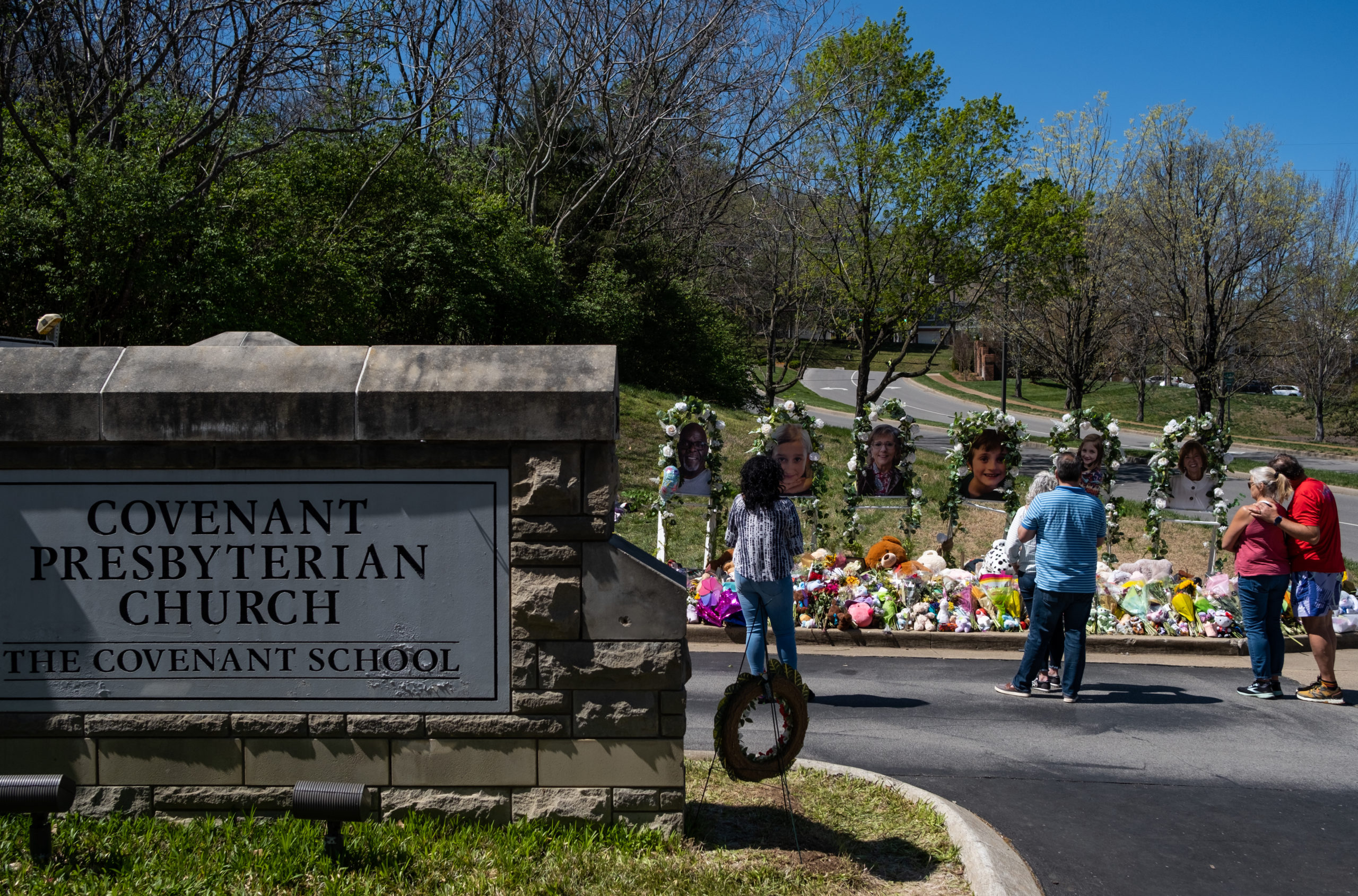 People visit a makeshift memorial at the entrance of The Covenant School on April 1, 2023 in Nashville, Tennessee. Three students and three adults were killed by the 28-year-old shooter on Monday. (Photo by Seth Herald/Getty Images)