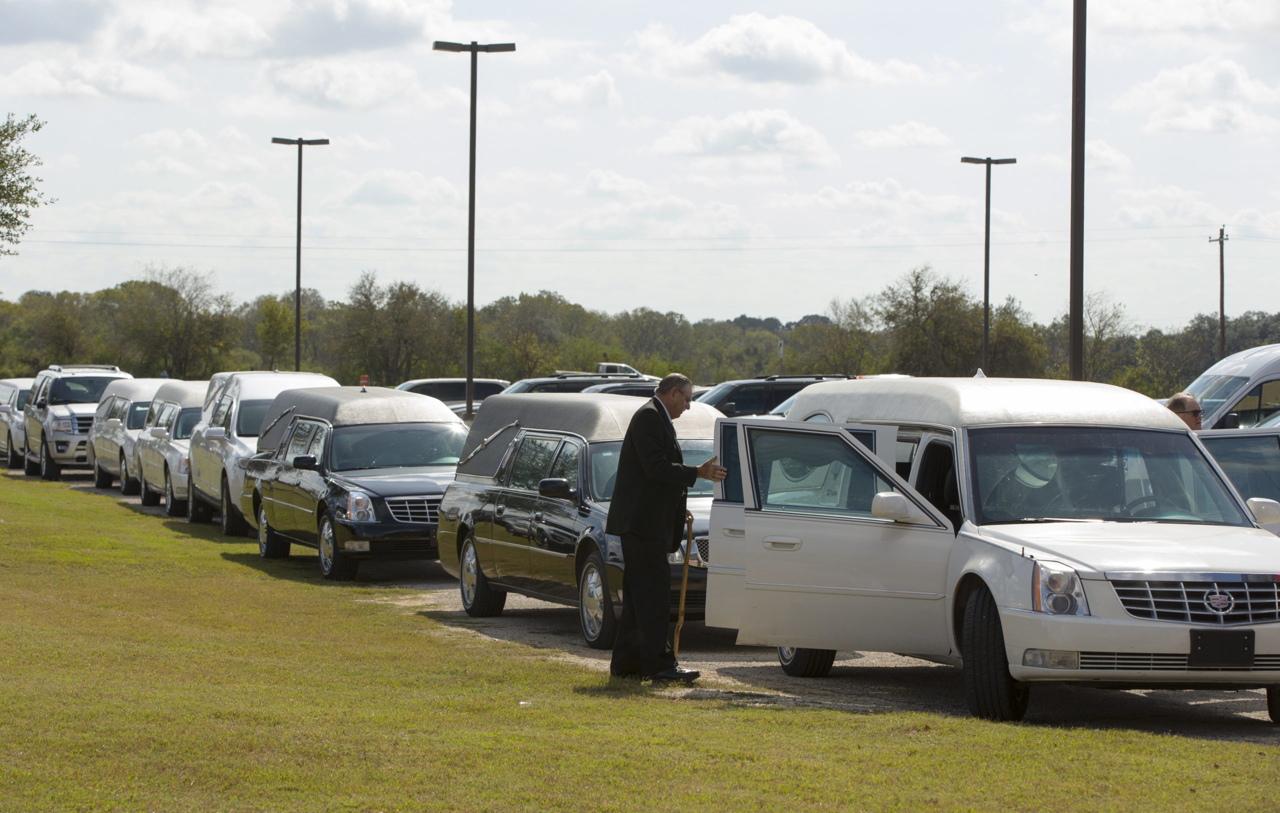 FLORESVILLE, TX - NOVEMBER 15: Hearses line up for the memorial service held at the Floresville Events Center on November 15, 2017 in Floresville, Texas for the nine members of the Holcombe family killed in the Sutherland Springs church shooting. 26 people were killed and 20 others wounded when Devin Patrick Kelley opened fire during Sunday service at the church on November 5th. (Photo by Erich Schlegel/Getty Images)