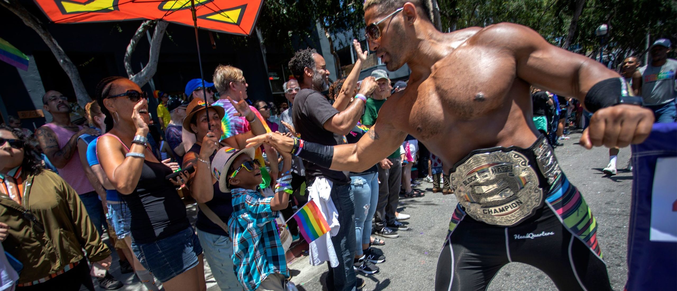 A boy is greeted by a participant during the annual LA Pride Parade in West Hollywood, California, on June 9, 2019. (DAVID MCNEW/AFP via Getty Images)