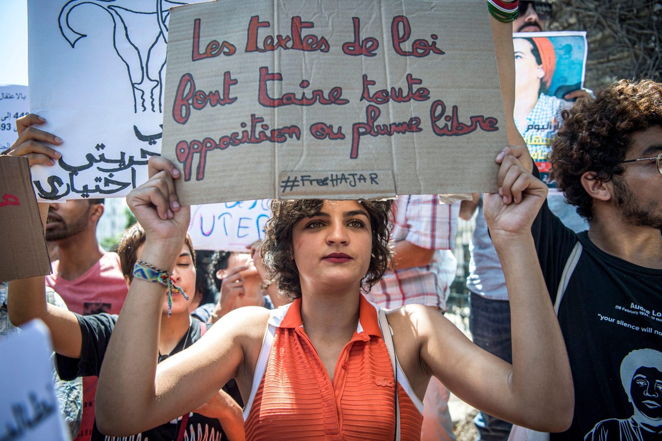 A demonstrator holds up a sign reading in French "the texts of the law silence all opposition or freedom of speech", during a protest outside a courthouse holding the trial of Hajar Raissouni, a Moroccan journalist of the daily newspaper Akhbar El-Youm, on charges of abortion, in the capital Rabat on September 9, 2019. (Photo by FADEL SENNA / AFP) (Photo credit should read FADEL SENNA/AFP via Getty Images)