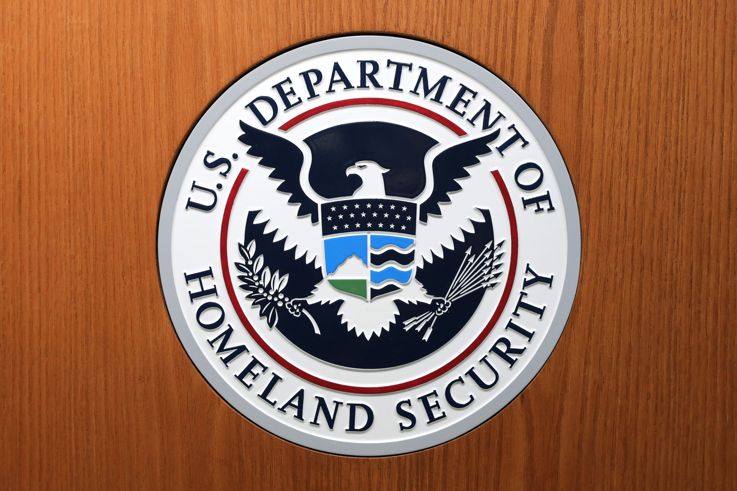WASHINGTON, DC - AUGUST 21: The Department of Homeland Security seal on the podium used by acting Secretary Kevin McAleenan as he announces new rules about how migrant children and families are treated in federal custody at the Ronald Reagan Building August 21, 2019 in Washington, DC. The Trump Administration announced the change in rules that would allow it to indefinitely detain migrant families who cross the border illegally, replacing the Flores Agreement which limited on how long the government could hold migrant children in custody and how they must be cared for. (Photo by Chip Somodevilla/Getty Images)