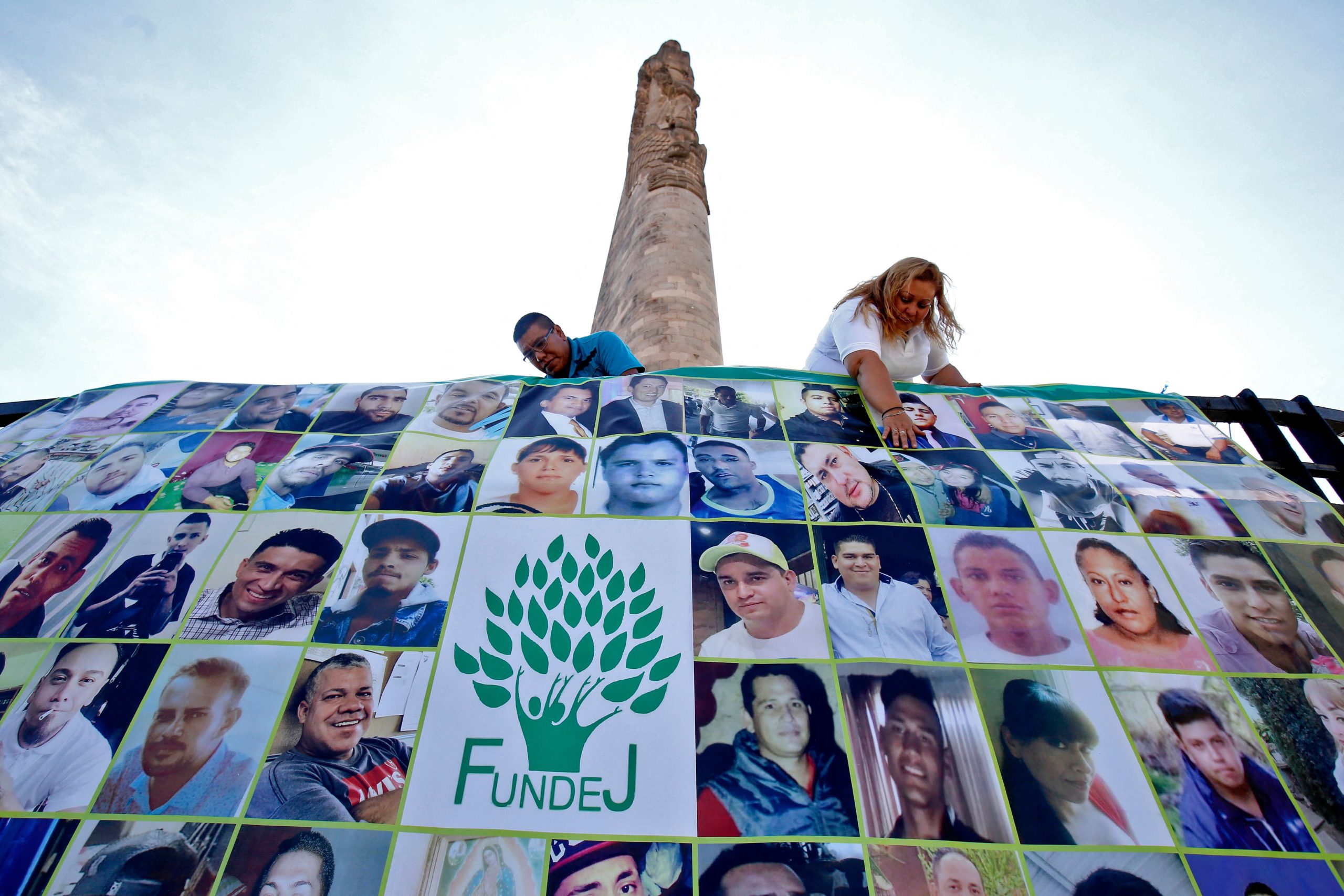 EDITORS NOTE: Graphic content / TOPSHOT - Members of the Familias Unidas por Nuestros desaparecidos Jalisco (United Families for Our Disappeared Jalisco, FUNDEJ) association prepare a banner with portraits of disappeared people in Guadalajara, Jalisco State, Mexico, on November 22, 2019. - AFP has mobilized several of its photographers in Mexico around a project entitled Twenty-four hours in Mexico in the shadow of violence to capture, from Thursday, November 21 at midnight to Friday, November 22, scenes of ordinary violence. Since December 2006, after the beginning of the federal anti-cartel offensive, there have been more than 250,000 murders reported in Mexico. (Photo by Ulises Ruiz / AFP) (Photo by ULISES RUIZ/AFP via Getty Images)