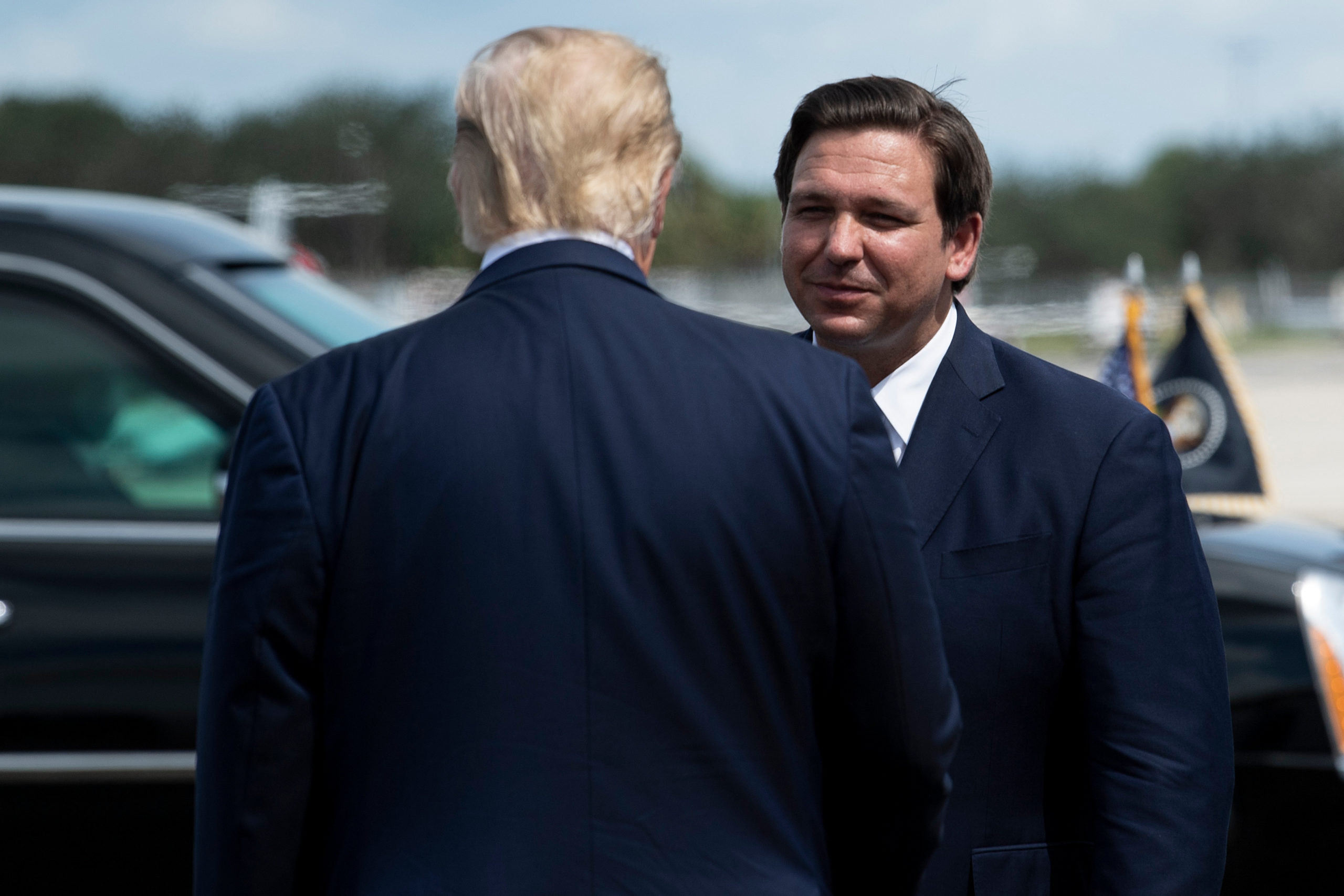 US President Donald Trump is greeted by Florida Governor Ron DeSantis at Southwest Florida International Airport October 16, 2020, in Fort Myers, Florida. 