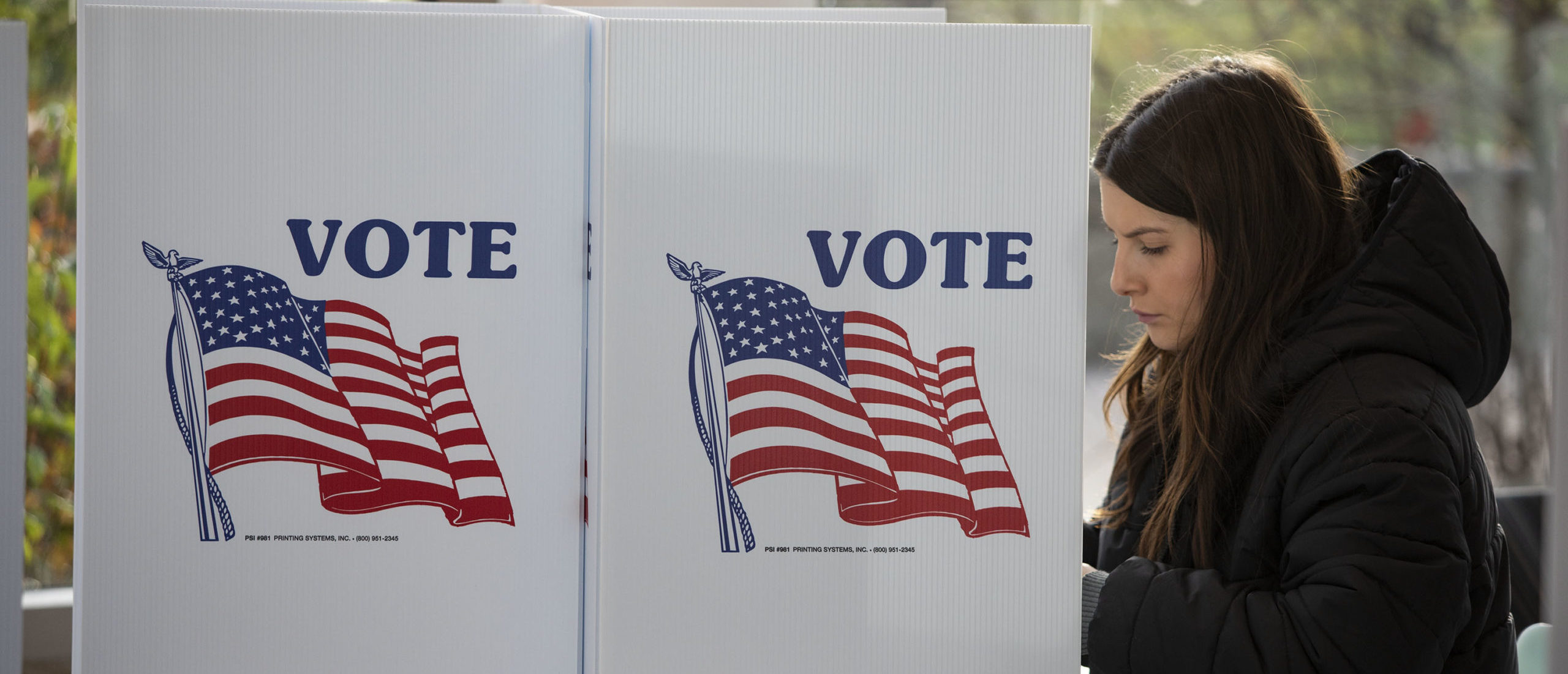 A woman votes in the 2022 midterm election on Election Day at a polling location on the Michigan State University campus on November 8, 2022 in East Lansing, Michigan.