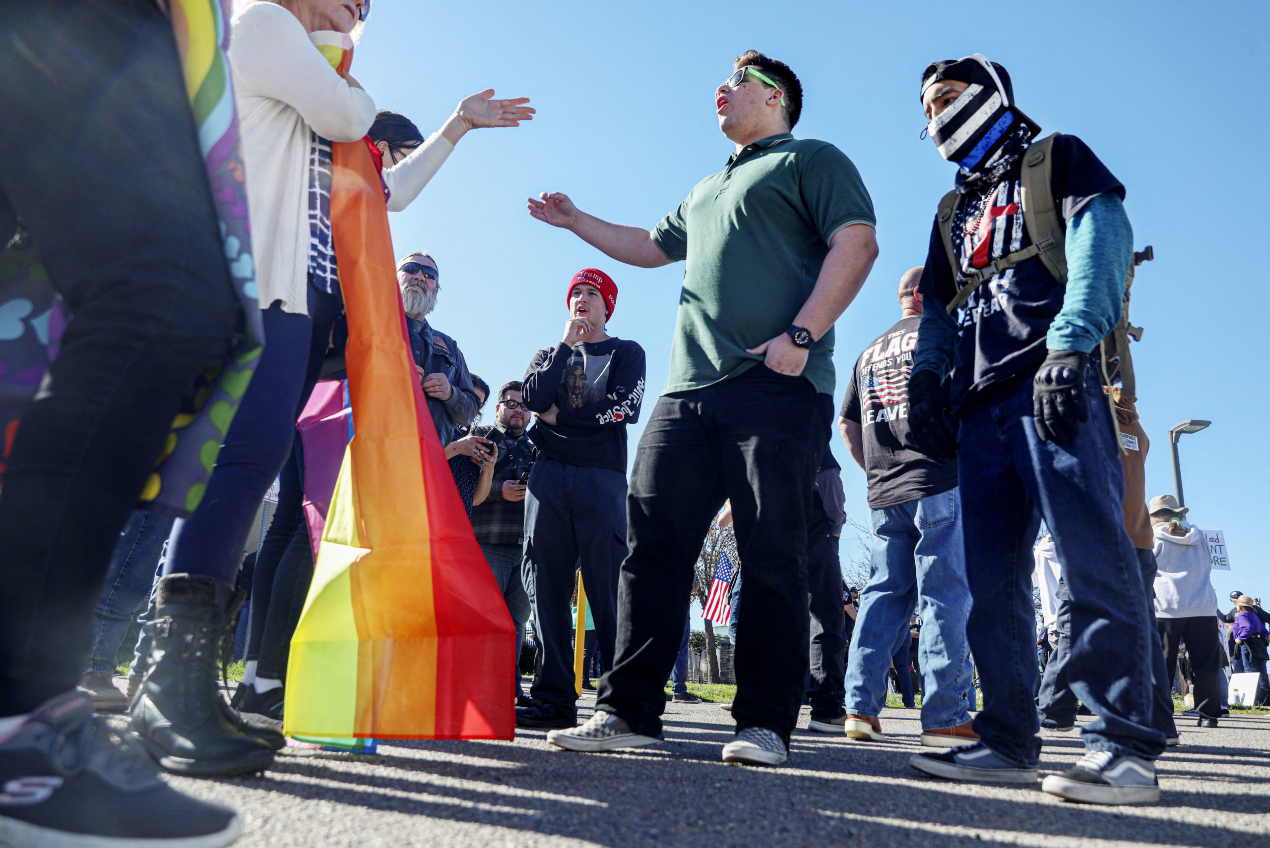 Pro-gender rights activist (L) face off against protesters rallying against Christynne Wood, a transgender woman who was criticized for using the female locker room at the YMCA, in Santee, a suburban city in San Diego County California, January 21, 2023. 
