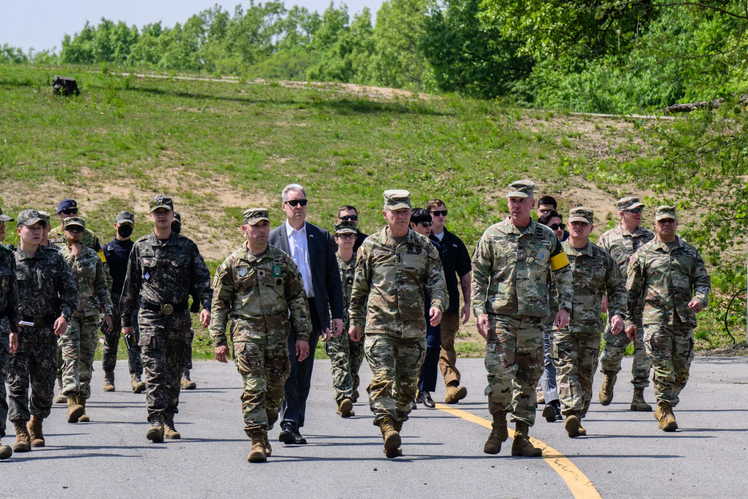 In this photo taken on May 9, 2023, US Army Chief of Staff General James McConville (front C) arrives at the Joint Security Area (JSA) in the Demilitarized Zone (DMZ), in the border village of Panmunjom in Paju. South Korea and Japan's efforts to improve their once-strained relationship and boost military ties are key to countering North Korea, America's top general said. 