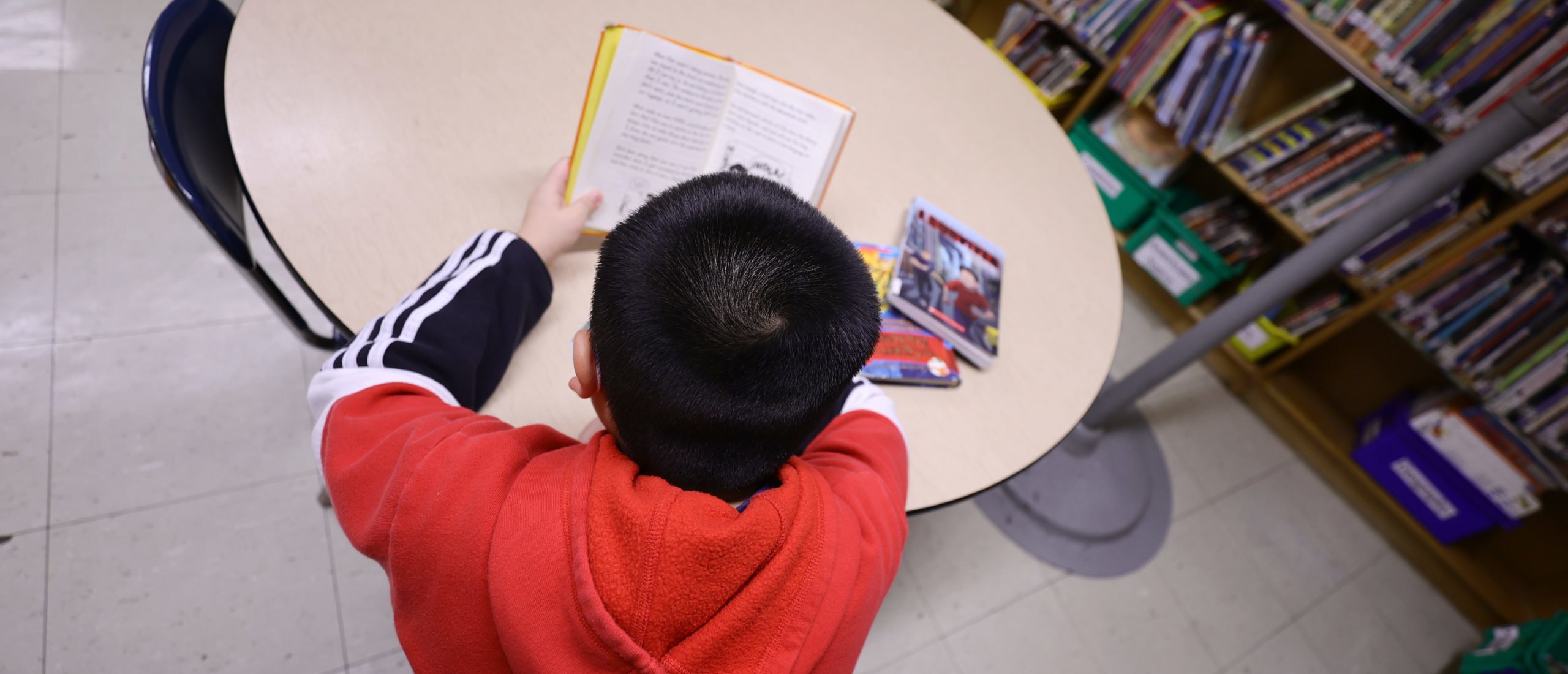A student in the library reads a book after receiving candy and a red envelope in a cultural celebration of the Lunar New Year at Yung Wing School P.S. 124 on February 02, 2022 in New York City. NYC schools were closed yesterday in observance of what is considered the most important day in the Chinese calendar with the start of the New Year. This event is not only relevant in Asia, but also in other countries where this Chinese tradition is respected and celebrated and is on the table to become the next US Federal Holiday. (Photo by Michael Loccisano/Getty Images)