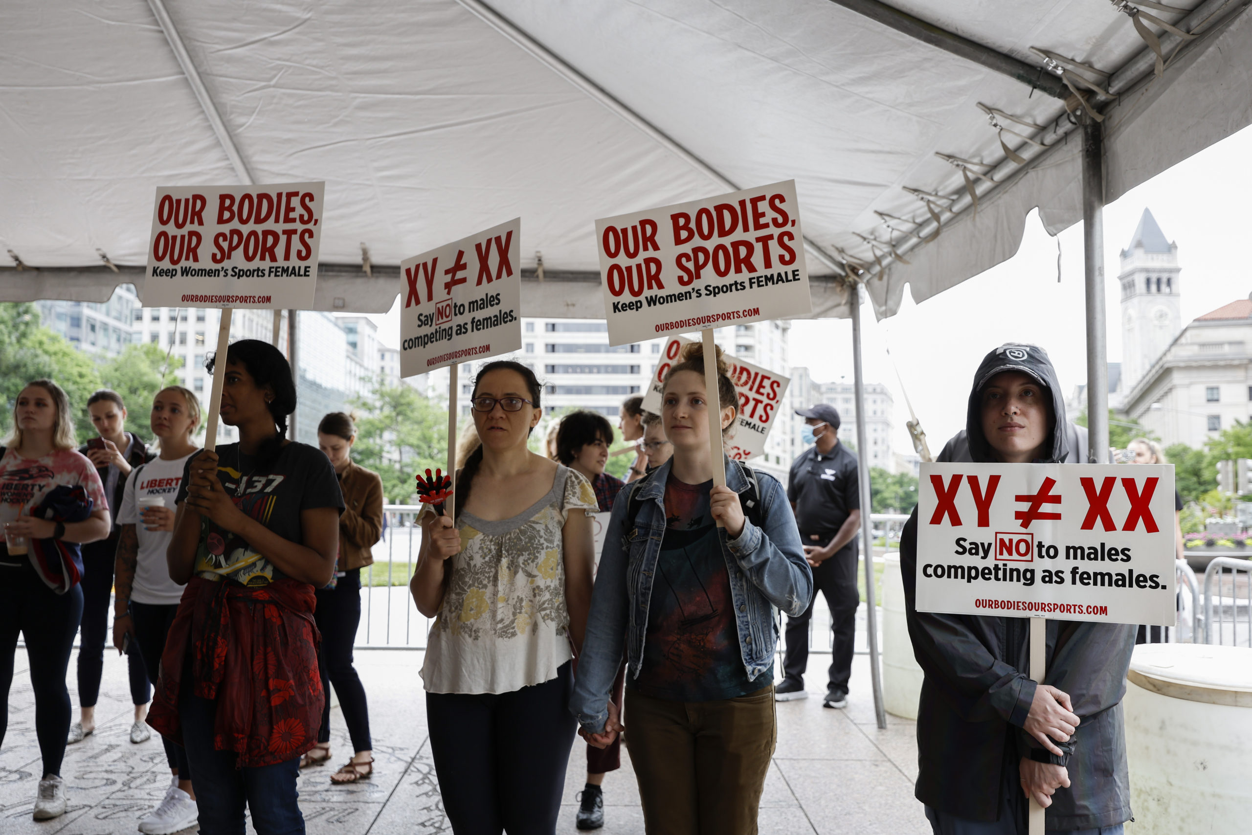 Demonstrators listen to the speaking program during an "Our Bodies, Our Sports" rally for the 50th anniversary of Title IX at Freedom Plaza on June 23, 2022 in Washington, DC. 