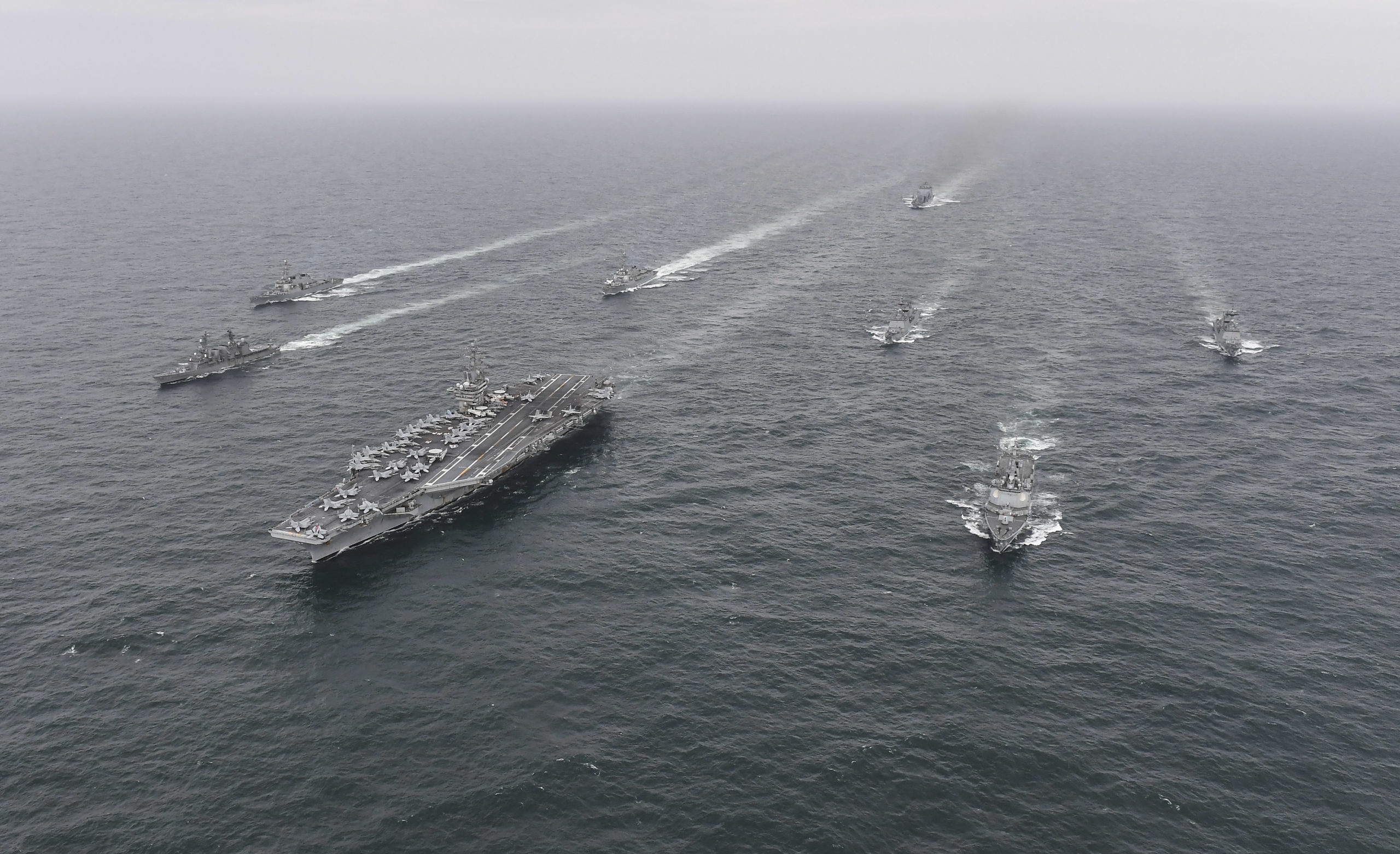UNDISCLOSED LOCATION, AT SEA - APRIL 04: In this handout image released by the South Korean Defense Ministry, South Korean Navy's destroyer Yulgok Yi I (R) U.S. Navy's aircraft carrier USS Nimitz (C) and Japan Maritime Self-Defense Force's Umigiri, (L) sail in formation during a joint naval exercise in international waters off South Korea's southern island of Jeju on April 04, 2023 at an undisclosed location. South Korea, the United States and Japan kicked off a trilateral naval exercise, involving an American aircraft carrier, in waters south of the Korean Peninsula amid joint efforts to reinforce deterrence against growing North Korean threats. 