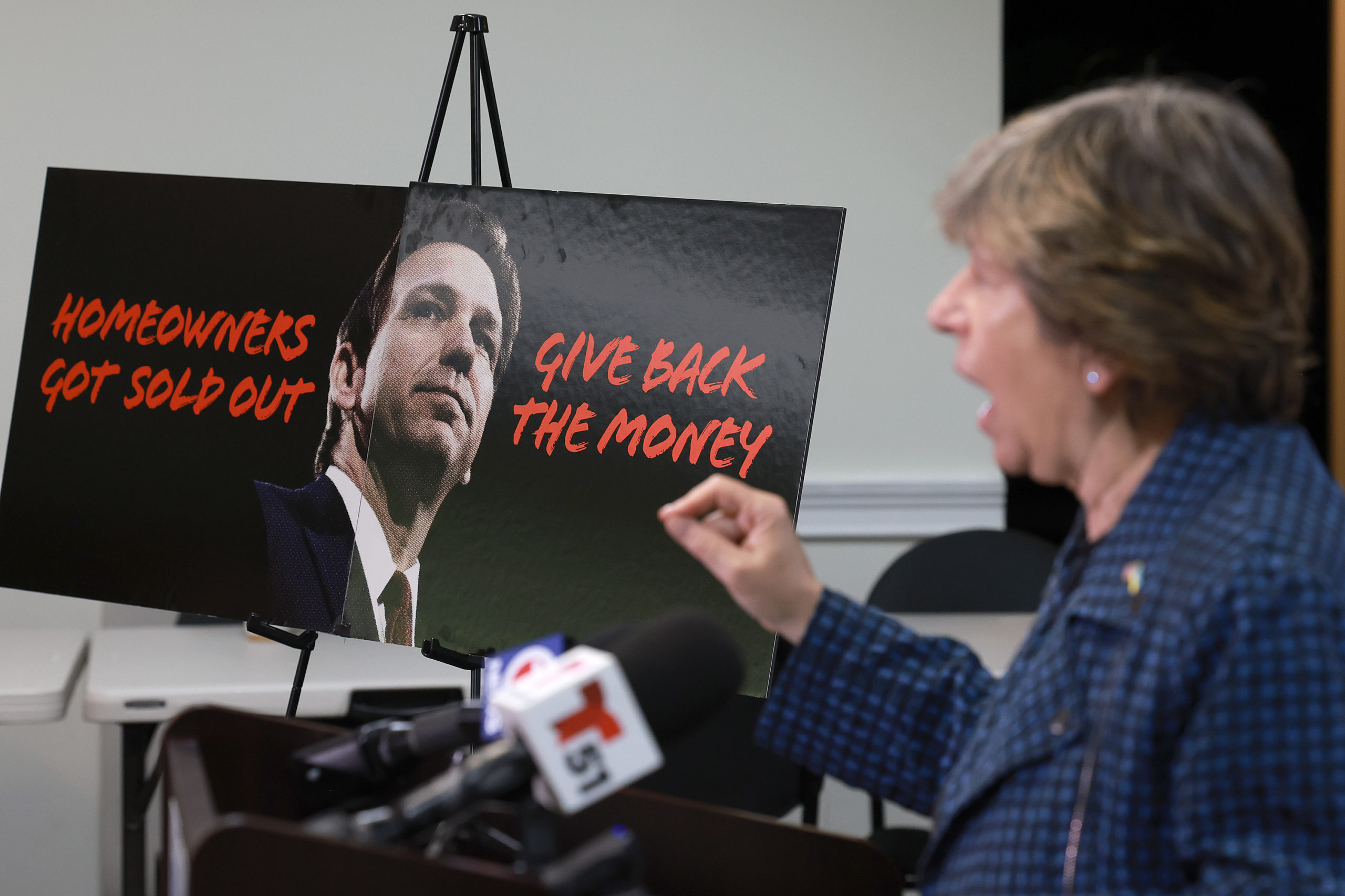 A poster with a picture of Florida Governor Ron DeSantis is posted next to Randi Weingarten, President American Federation of Teachers, as she speaks during a press conference condemning the Governor and his alleged role in insurance costs skyrocketing for Floridians on May 03, 2023 Tamarac, Florida. Florida's average home insurance costs have nearly doubled. As a result, teachers, middle-class and poor people are having difficulty affording the cost of owning or renting a home and now pay about three times the national average. (Photo by Joe Raedle/Getty Images)