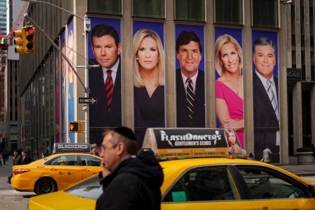 NEW YORK, NY - MARCH 13: Traffic on Sixth Avenue passes by advertisements featuring Fox News personalities, including Bret Baier, Martha MacCallum, Tucker Carlson, Laura Ingraham, and Sean Hannity, adorn the front of the News Corporation building, March 13, 2019 in New York City. On Wednesday the network's sales executives are hosting an event for advertisers to promote Fox News. Fox News personalities Tucker Carlson and Jeanine Pirro have come under criticism in recent weeks for controversial comments and multiple advertisers have pulled away from their shows. (Photo by Drew Angerer/Getty Images)