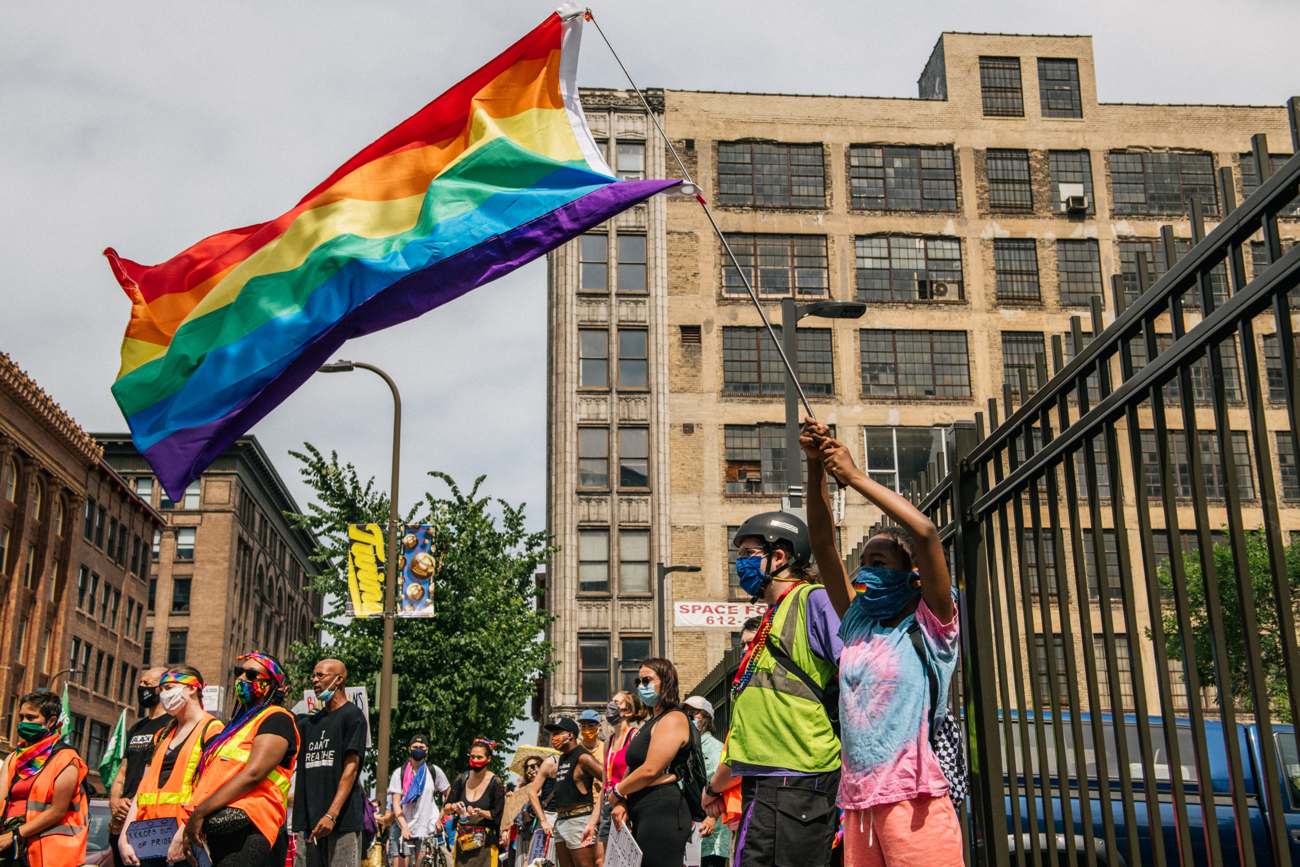 A girl waves a flag as people gather in front of the Minneapolis First Precinct during a Pride march on June 28, 2020 in Minneapolis, Minnesota. The demonstration was a call for justice for George Floyd, and all victims of police murder. Demonstrators rallied to defend Black trans lives and demand community control of law enforcement. (Photo by Brandon Bell/Getty Images)