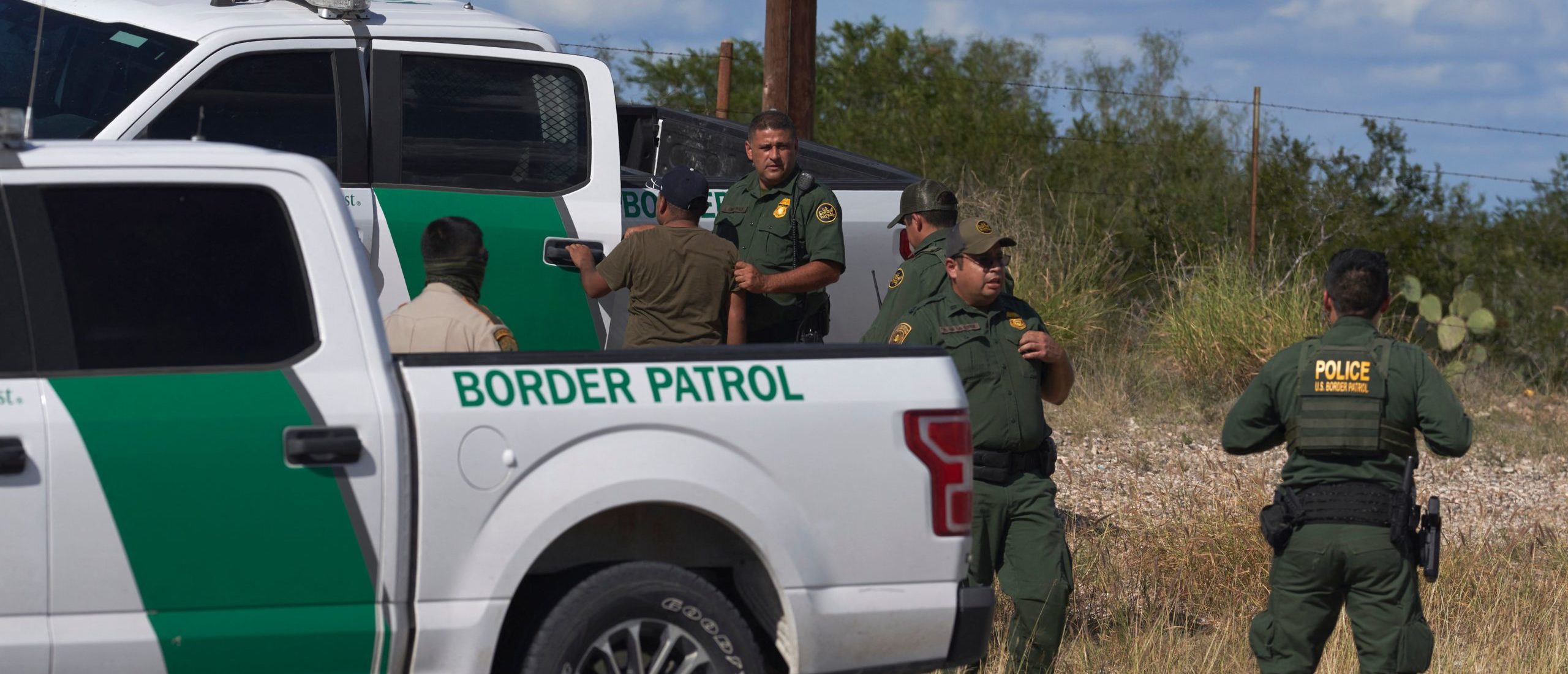 An illegal migrant found smuggled in a vehicle is apprehended by US Border Patrol and the Webb County Sheriff on October 12, 2022 in Laredo, Texas. (Photo by allison dinner / AFP) (Photo by ALLISON DINNER/AFP via Getty Images)