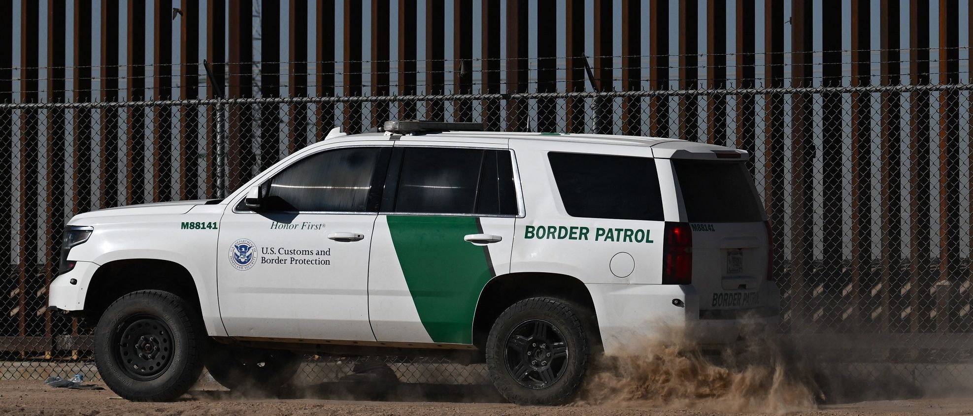 A US Customs and Border Protection Border Patrol vehicle is driven along the US-Mexico border wall in El Paso, Texas on May 10, 2023. (Photo by PATRICK T. FALLON/AFP via Getty Images)