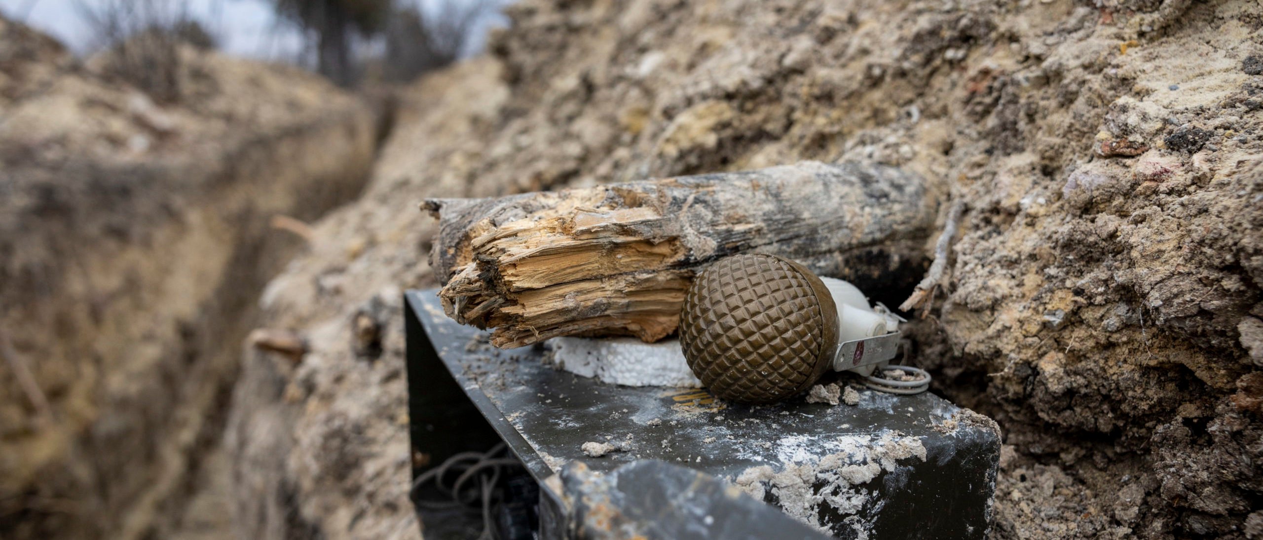 A grenade lies next to a piece of wood in a frontline trench. Image not from story. (Photo by John Moore/Getty Images)