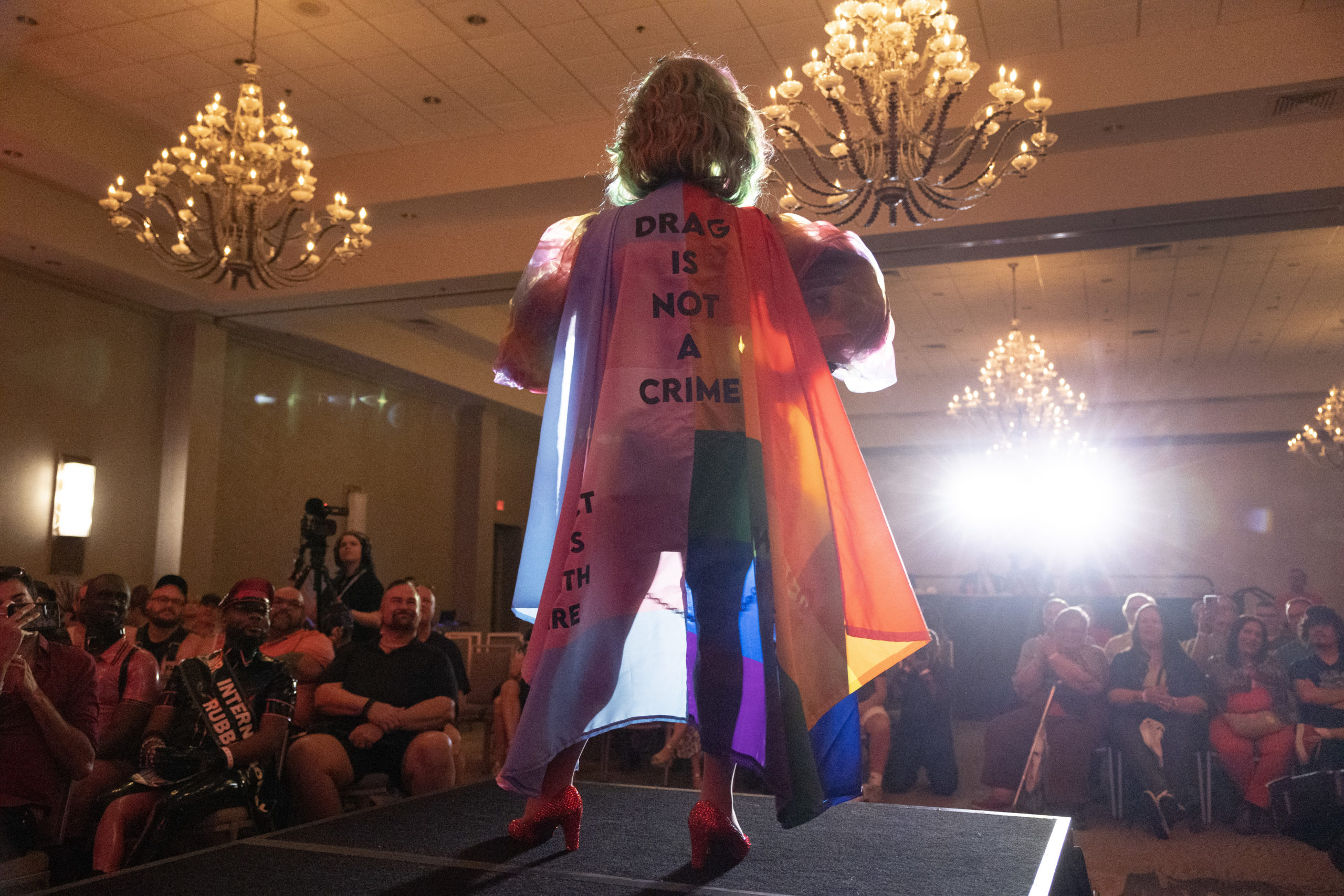 ORLANDO, FLORIDA - JUNE 03: Salem Sanderson wears a cape that reads "Drag is Not a Crime" as she performs during the Miss Gay Days Pageant at the DoubleTree by Hilton Orlando at SeaWorld on June 03, 2023 in Orlando, Florida. As Florida Gov. Ron DeSantis and Florida lawmakers passed anti-LGBTQ laws, Gay Days organizers encouraged visitors to continue to attend one of Florida’s largest gay and lesbian celebrations. One part of the festivities for the weekend will be a Saturday meetup of LGBTQ visitors at Magic Kingdom in the Walt Disney World theme park, even as Disney is in a legal fight with DeSantis over the governor and Florida Republican lawmakers taking over Disney World’s governing district after Disney officials publicly opposed legislation that critics have dubbed “Don’t Say, Gay.” (Photo by Joe Raedle/Getty Images)