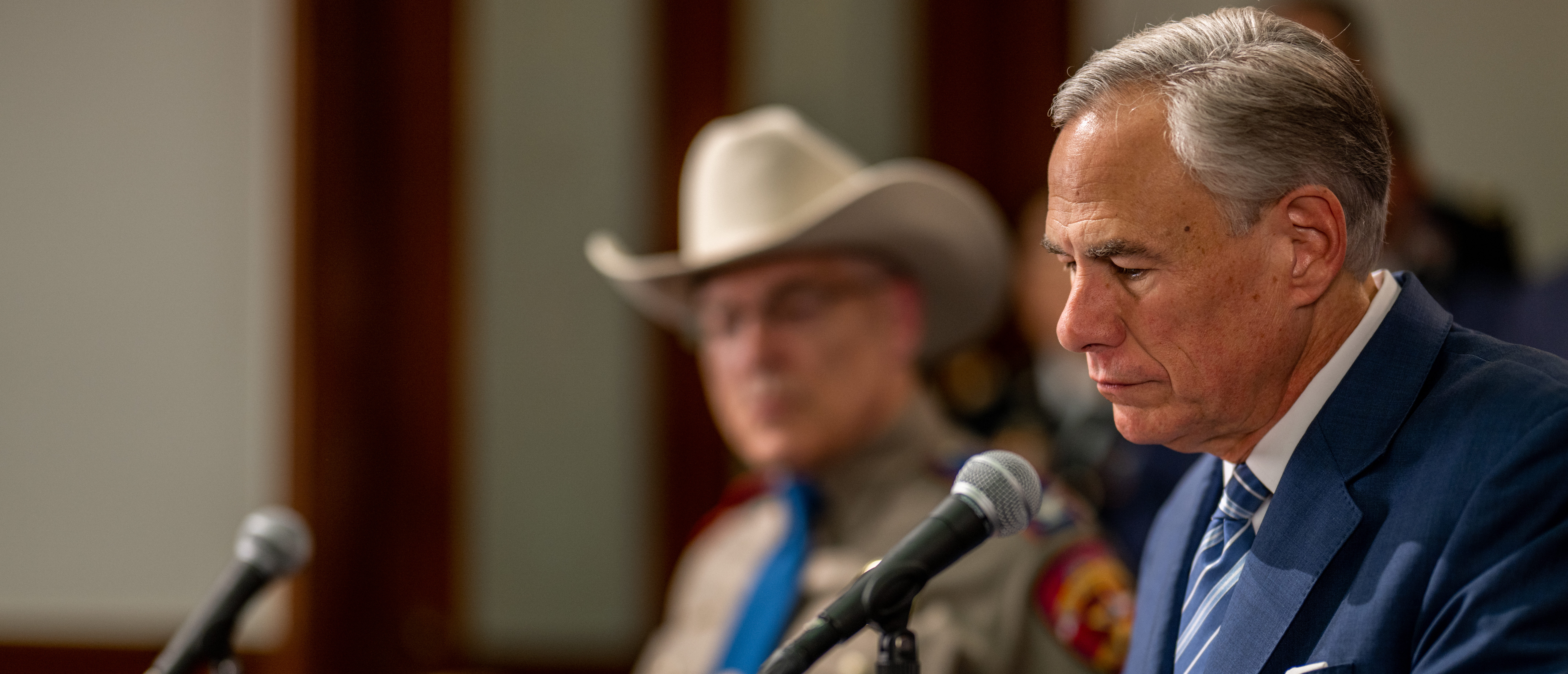 Texas Gov. Greg Abbott glances over a bill before signing during a news conference at the state Capitol on June 08, 2023 in Austin, Texas. Abbott and Texas Department of Public Safety Director Steve McCraw joined bill authors, sponsors, legislators and law enforcement members in the signing of bills aimed at enhancing southern border security. (Photo by Brandon Bell/Getty Images)