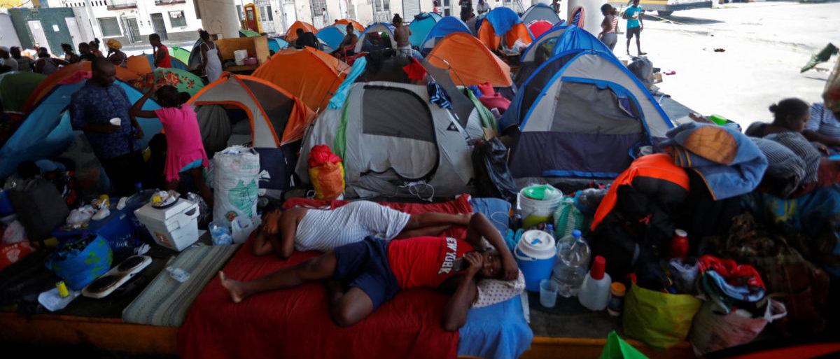 Haitian asylum seekers set up camp in an abandoned gas station while they wait to attempt to cross into the U.S. by an appointment through the Customs and Border Protection app, called CBP One, at a makeshift camp, in Matamoros, Mexico June 21, 2023. President Joe Biden promised to replace the hardline policies of former President Donald Trump, including the COVID-era public health order Title 42, with a more humane immigration system. The new Biden regulation allows migrants once again to ask for asylum at the border, but wait in Mexico for a slot on the app or risk a sped-up deportation process that could be conducted while they are held in detention. But in the first month of the new policy, Reuters found tens of thousands of people are waiting in dangerous Mexican border towns to snag a spot on the app, according to U.S. and Mexican officials, amid warnings from humanitarian groups of deteriorating sanitary conditions at migrant camps. REUTERS/Daniel Becerril SEARCH "BECERRIL GONZALEZ ASYLUM" FOR THIS STORY. SEARCH "WIDER IMAGE" FOR ALL STORIES.