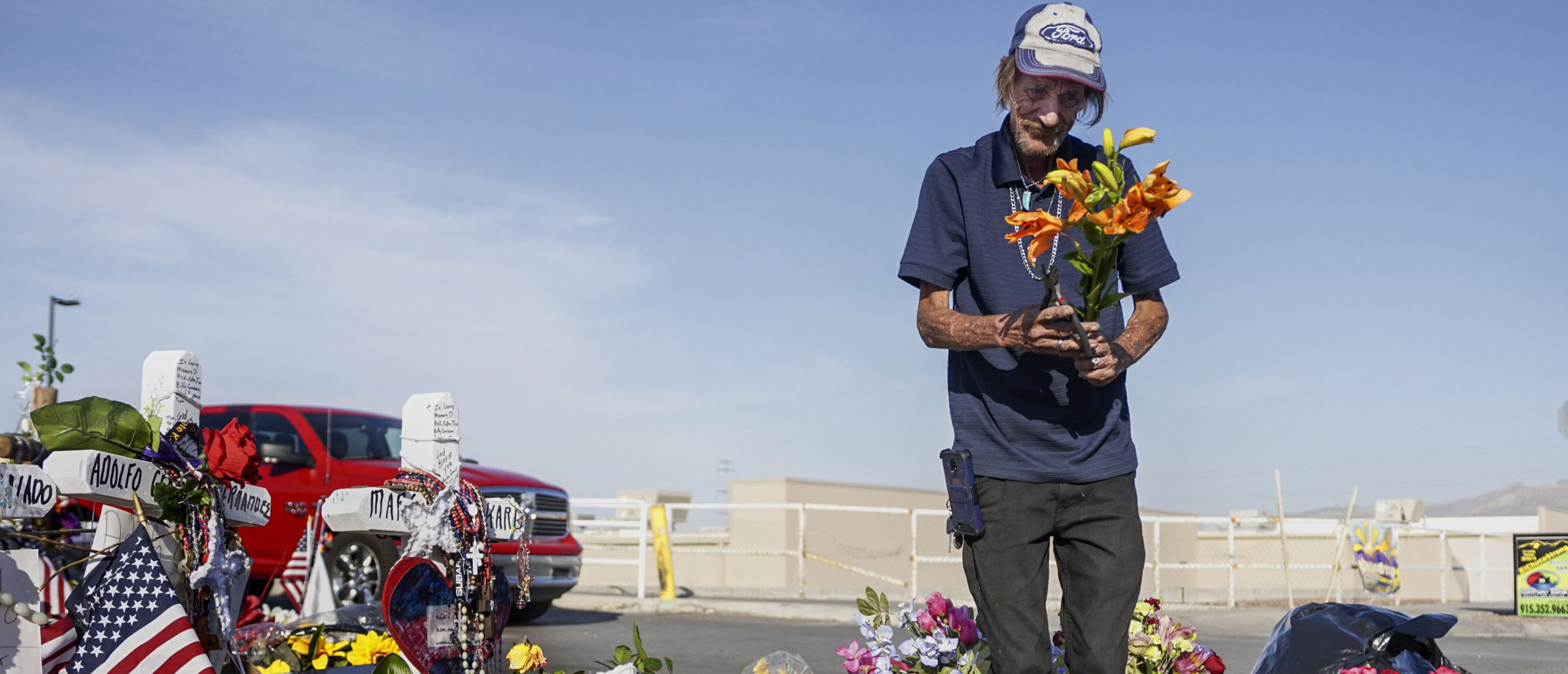 EL PASO, TX - AUGUST 16: Antonio Basco, who's wife Margie Reckard was one of 22 persons killed by a gunman at a local Walmart, lays flowers in her honor at a makeshift memorial near the scene on August 16, 2019 in El Paso, Texas. Basco has been to the memorial everyday site since it was erected to clean up the area and put out fresh flowers. 22 people were killed in Walmart during a mass shooting on August 3rd. A 21-year-old white male suspect remains in custody in El Paso which sits along the U.S.-Mexico border. (Photo by Sandy Huffaker/Getty Images)