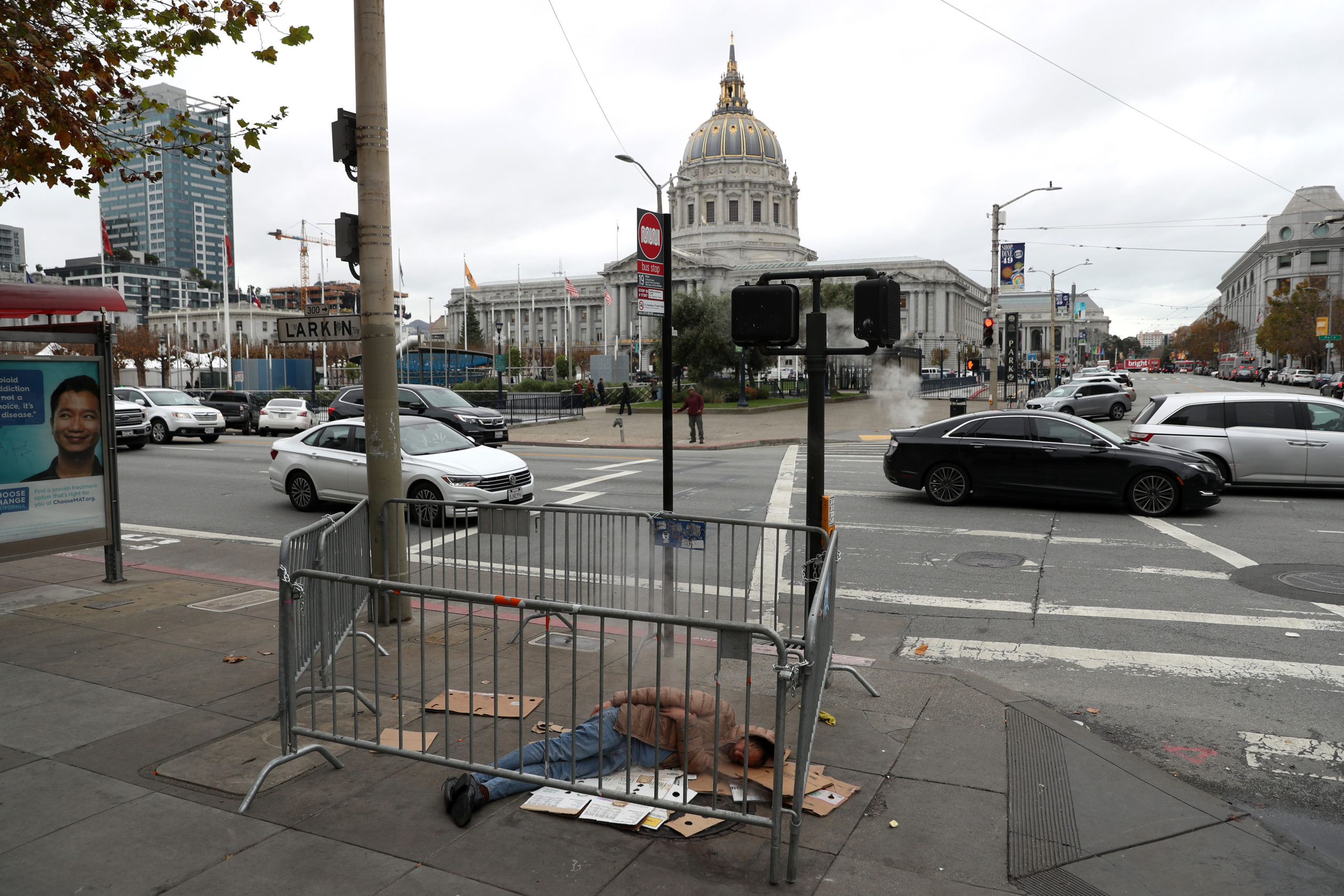 SAN FRANCISCO, CALIFORNIA - DECEMBER 05: A homeless man sleeps on the sidewalk near San Francisco City Hall on December 05, 2019 in San Francisco, California. California Gov. Gavin Newsom announced plans to release $650 million in emergency aid that will allocated to California cities and counties in an effort to combat the state's homelessness crisis. (Photo by Justin Sullivan/Getty Images)