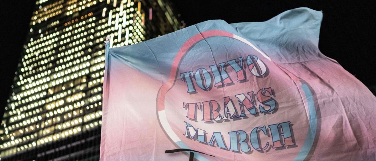 A participant (unseen) holds a flag during the International Transgender Day of Visibility rally in Shibuya district of Tokyo on March 31, 2023. (Photo by YUICHI YAMAZAKI/AFP via Getty Images)