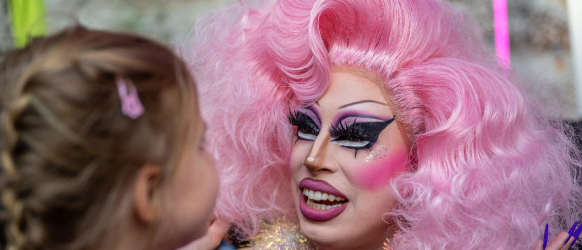 AUSTIN, TEXAS - MARCH 11: Drag Queen Brigitte Bandit speaks with Keanya Philyan, 5, during a story time reading at the Cheer Up Charlies dive bar on March 11, 2023 in Austin, Texas. (Photo by Brandon Bell/Getty Images