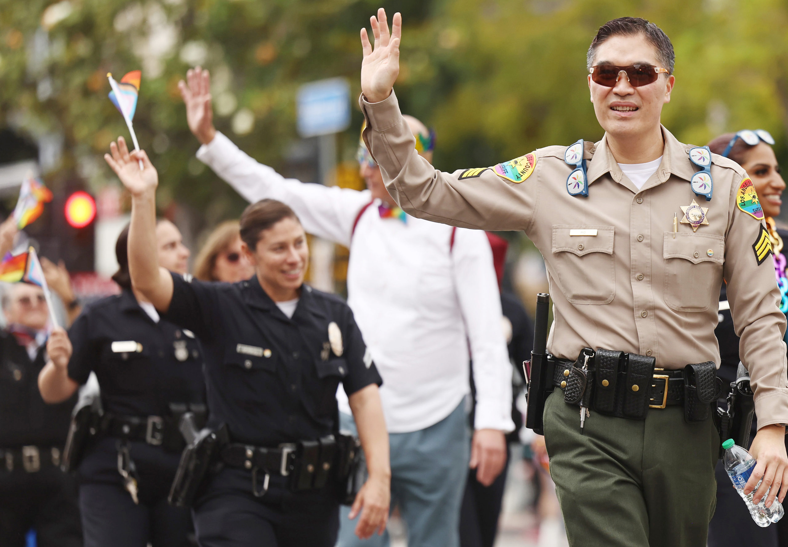 LOS ANGELES, CALIFORNIA - JUNE 11: Los Angeles police officers wave while participating in the 2023 LA Pride Parade in Hollywood on June 11, 2023 in Los Angeles, California. (Photo by Mario Tama/Getty Images)
