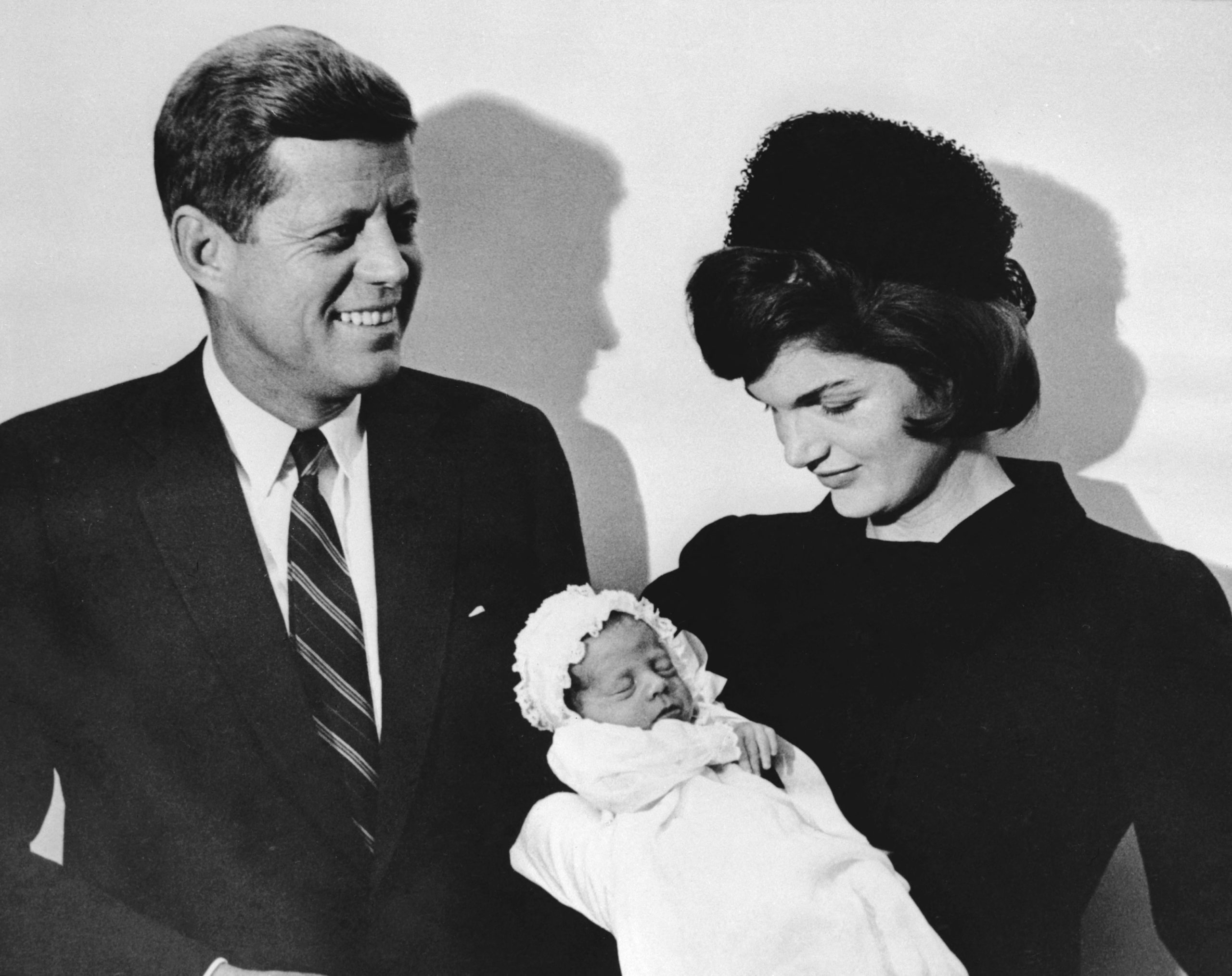 This December 10, 1960 photo shows John F. Kennedy and his wife Jacqueline holding their son John during the christening ceremony at the chapel of Georgetown University in Washington, DC. (Photo by Sam SCHULMAN / AFP) (Photo by SAM SCHULMAN/AFP via Getty Images)