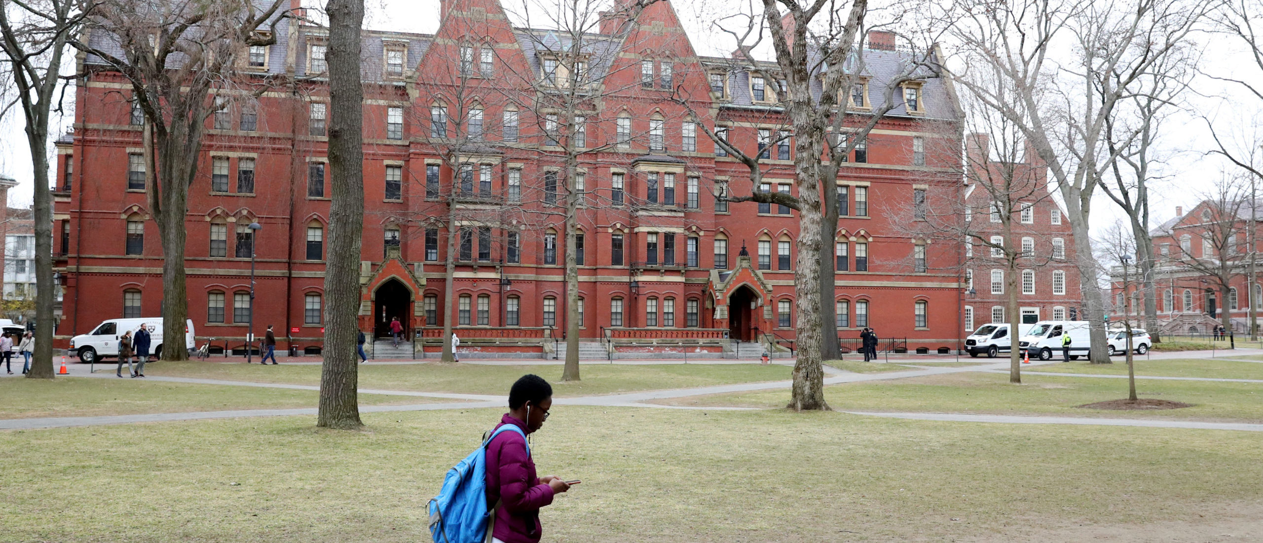 CAMBRIDGE, MASSACHUSETTS - MARCH 12: A student walks through Harvard Yard on the campus of Harvard University on March 12, 2020 in Cambridge, Massachusetts. Students have been asked to move out of their dorms by March 15 due to the Coronavirus (COVID-19) risk. All classes will be moved online for the rest of the spring semester. (Photo by Maddie Meyer/Getty Images)