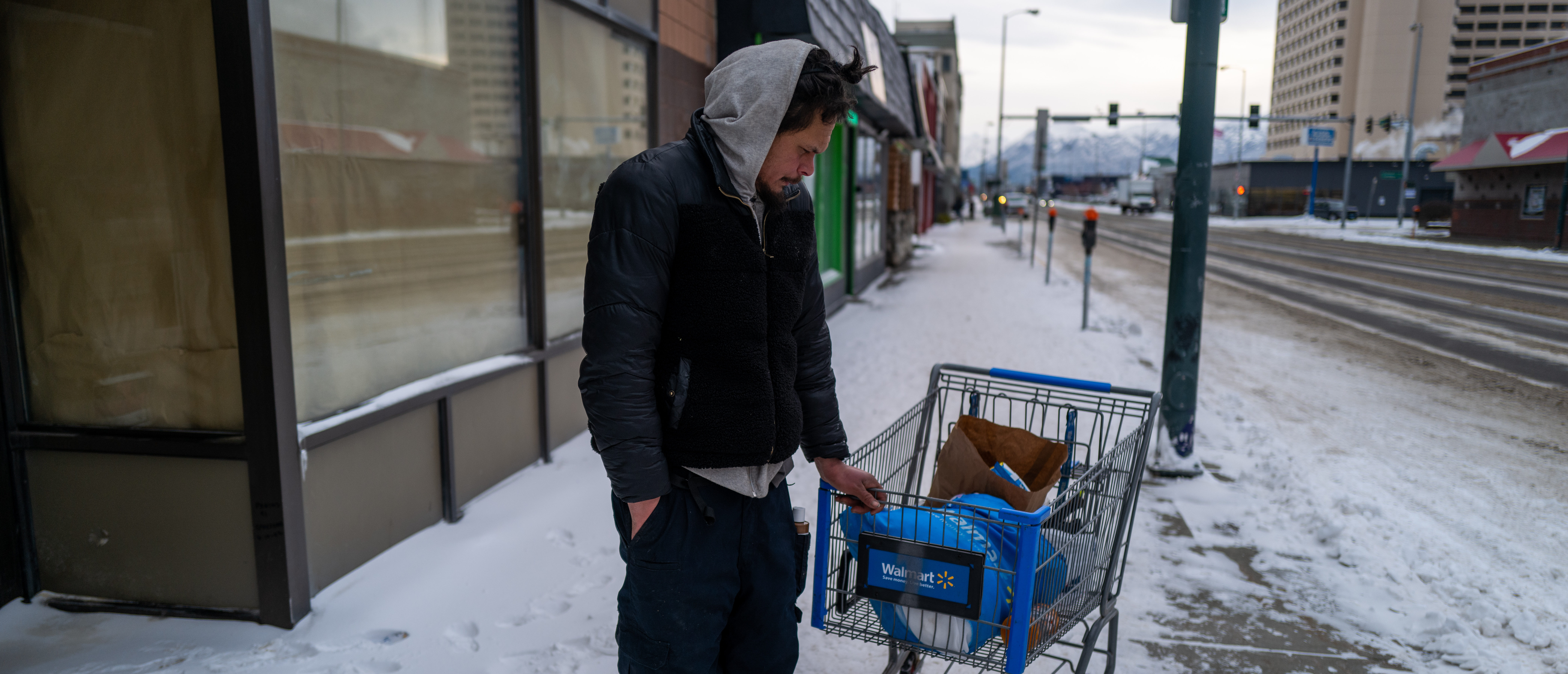 ANCHORAGE, ALASKA - NOVEMBER 07: A man pauses on a street downtown where homelessness is a chronic problem, on November 07, 2022 in Anchorage, Alaska.