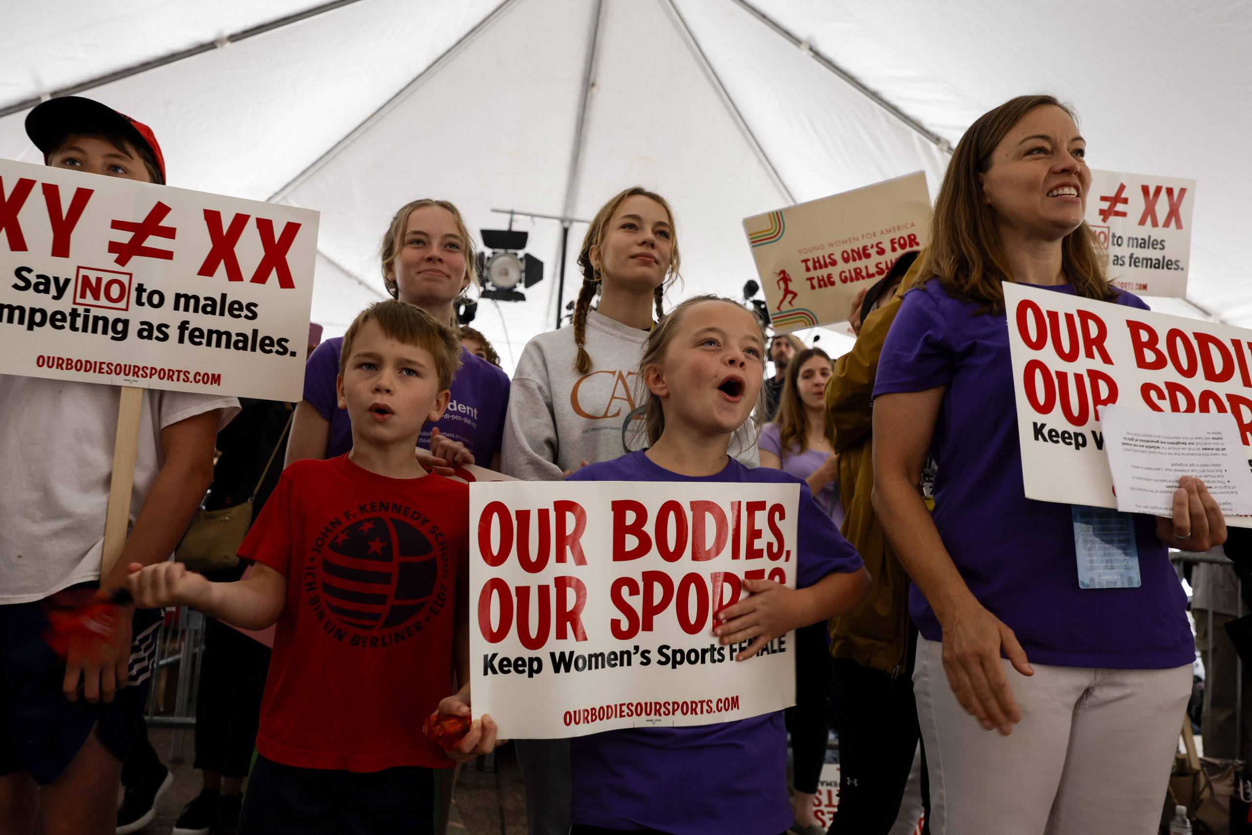 Demonstrators cheer during the speaking program at the "Our Bodies, Our Sports" rally for the 50th anniversary of Title IX at Freedom Plaza on June 23, 2022 in Washington, DC. The rally, organized by multiple athletic women's groups was held to call on U.S. President Joe Biden to put restrictions on transgender females and "advocate to keep women's sports female."(Photo by Anna Moneymaker/Getty Images)
