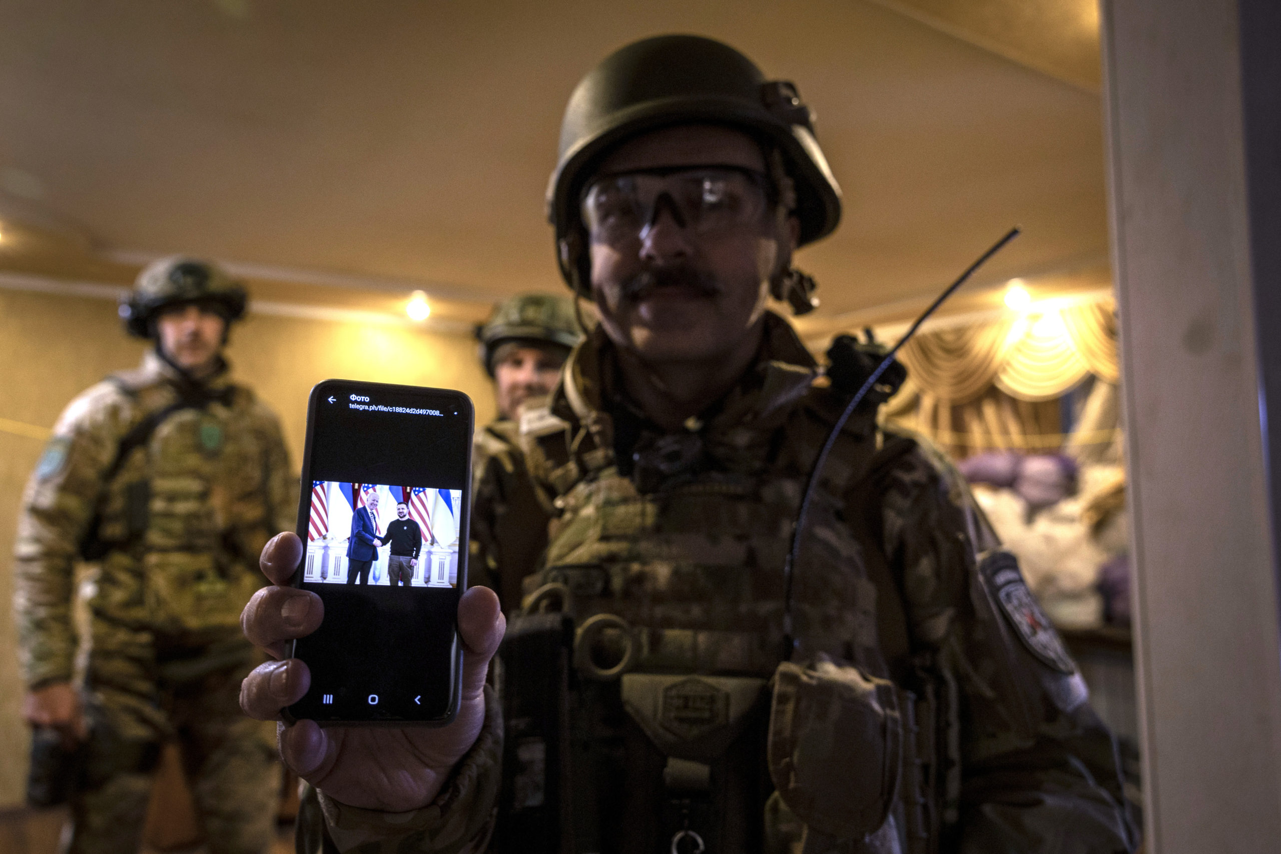 DONBAS, UKRAINE - FEBRUARY 20: Ukrainian paramedic "Austin" shows an image of U.S. President Joe Biden and Ukrainian President Volodymyr Zelensky on the day they met in Kyiv, while he and fellow medics were waiting for a call to transport wounded Ukrainian soldiers from frontline areas on February 20, 2023 in the Donbas region of eastern Ukraine. The paramedics, volunteering for Hospitallers, live in hidden locations close to the fighting, providing additional resources for evacuations to the military, which is often stretched thin. Hospitallers is a Ukrainian voluntary organization of doctors and paramedics who treat and evacuate soldiers from the battlefield. The group has more than 500 volunteers who work in two-week shifts as emergency responders. The organization relies on donations, both domestic and international, to fund the complex and often dangerous operation, including purchasing medical supplies and supporting the logistical needs of staff operating 32 ambulances and 76 pickup trucks, most in the war-torn Donbas region of eastern Ukraine. The volunteer paramedics come from a wide array of professions prior to joining Hospitallers and going through medical training. All are driven by the need to help Ukraine's war effort against Russia and relieve the suffering of wounded Ukrainian soldiers. Austin worked as a television camera operator in Kyiv before the war and joining Hospitallers. 