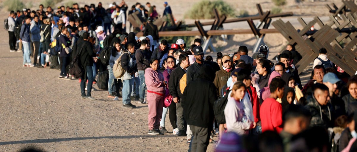 YUMA, ARIZONA - MAY 11: Immigrants seeking asylum in the United States wait in line near the border fence to be processed by U.S. Border Patrol agents after crossing into Arizona from Mexico on May 11, 2023 in Yuma, Arizona. A surge of immigrants is expected with today's end of the U.S. government's Covid-era Title 42 policy, which for the past three years has allowed for the quick expulsion of irregular migrants entering the country. Over 29,000 immigrants are currently in the custody of U.S. Customs and Border Protection ahead of the sunset of the policy tonight. (Photo by Mario Tama/Getty Images)