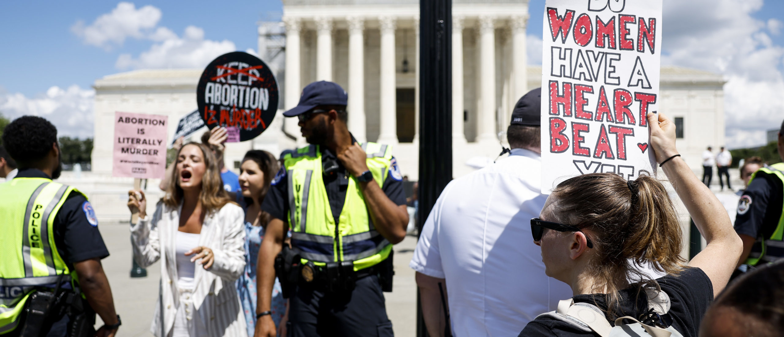 WASHINGTON, DC - JUNE 24: Anti-abortion activists protest near a Women's March rally in front of the U.S. Supreme Court Building on June 24, 2023 in Washington, DC. The rally was organized by abortion rights activists and held to mark the one year anniversary of the U.S. Supreme Court’s decision in Dobbs v Jackson Women’s Health, which overturned Roe v Wade and erased federal protections for abortions.