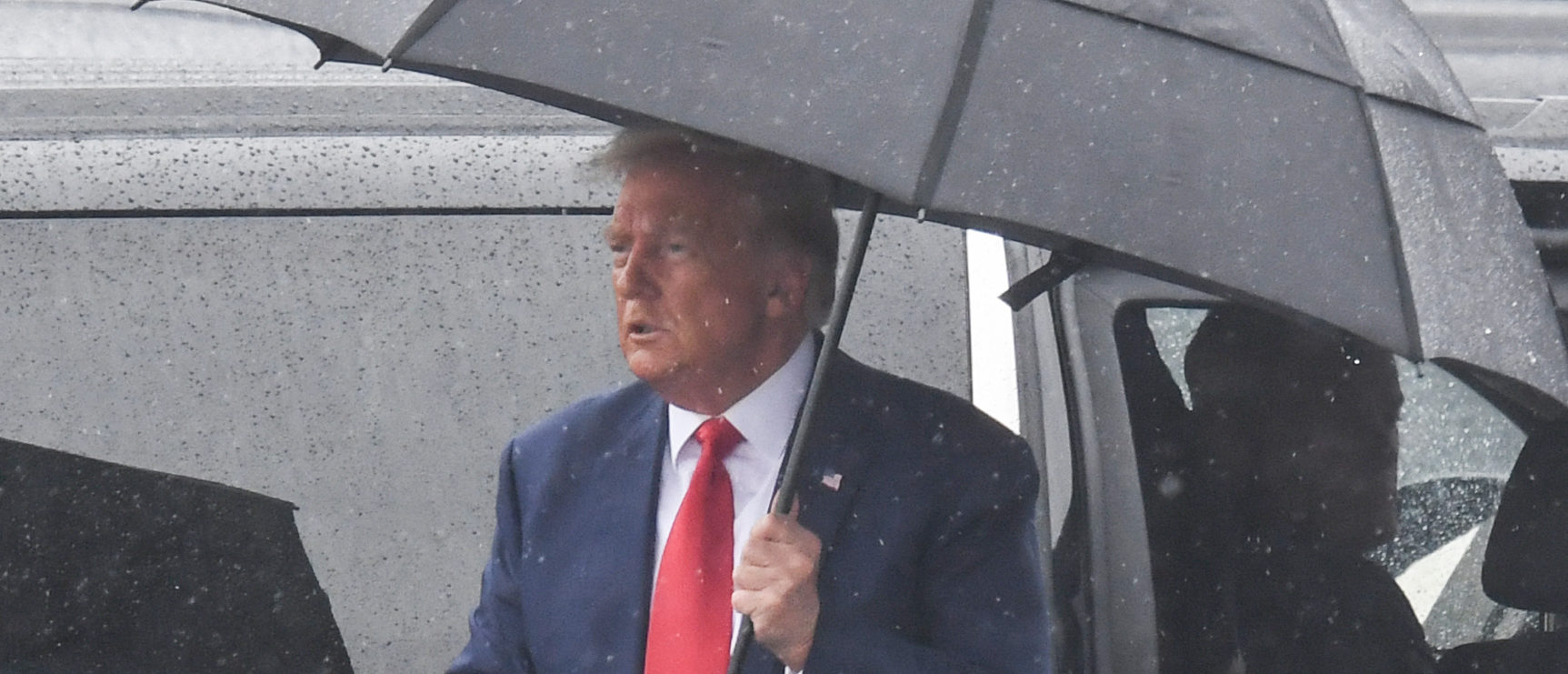 Former US President and 2024 hopeful Donald Trump arrives to Ronald Reagan Washington National Airport in Arlington, Virginia, on August 3, 2023, after his arraignment in court. Trump pleaded not guilty Thursday, August 3, to historic charges that he led a criminal conspiracy seeking to defraud the American people by overturning the 2020 election. The 77-year-old Republican told magistrate judge Moxila Upadhyaya he was pleading "not guilty" to all four counts against him. (Photo by OLIVIER DOULIERY / AFP) (Photo by OLIVIER DOULIERY/AFP via Getty Images)