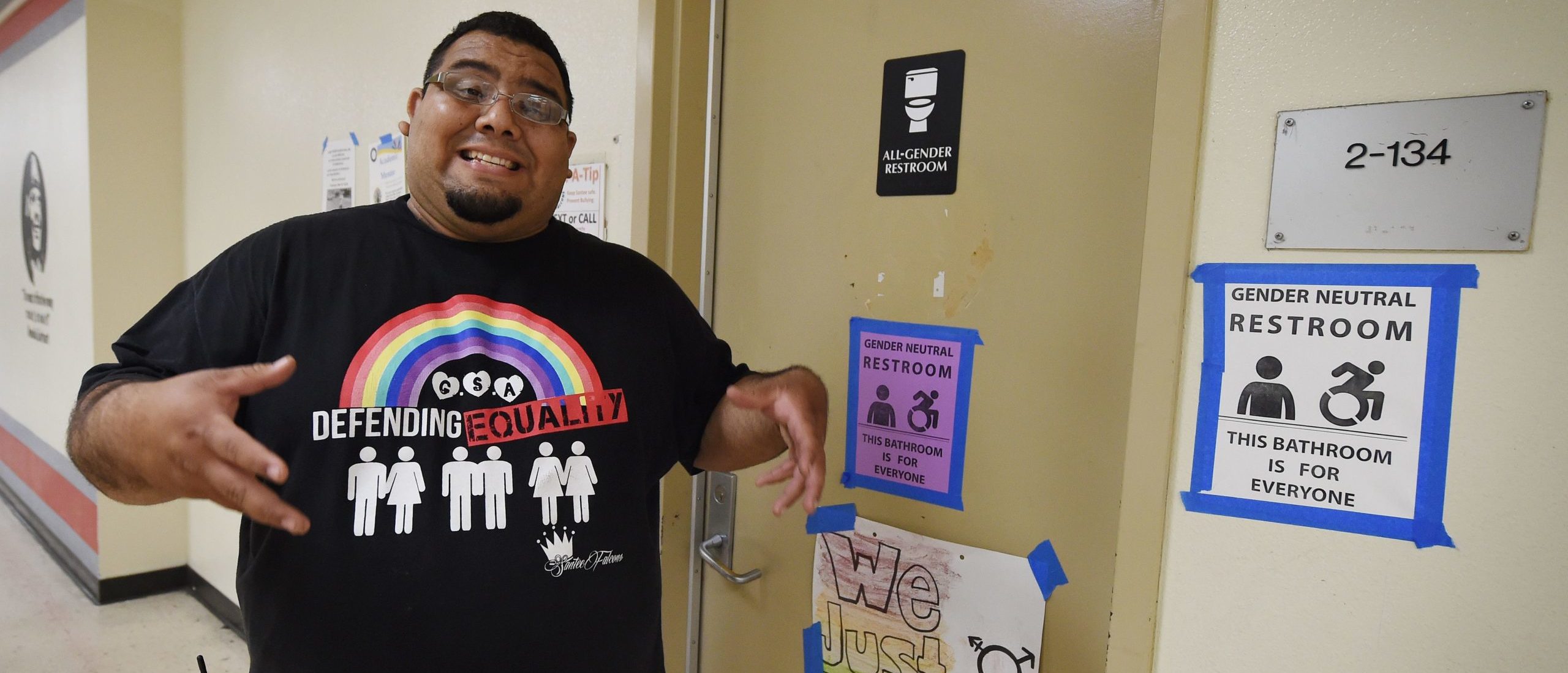 Jose Lara who is the Dean of the Santee High School talks to the press about the transgender issue beside the schools gender neutral restrooms at their campus in Los Angeles, California on May 4, 2016. There is an "emerging consensus worldwide" that the LGBT community should enjoy the same rights as everyone else, Washington's first envoy for gay rights said, but warned transgender people are still too often victims of violence. / AFP / Mark Ralston (Photo credit should read MARK RALSTON/AFP via Getty Images)