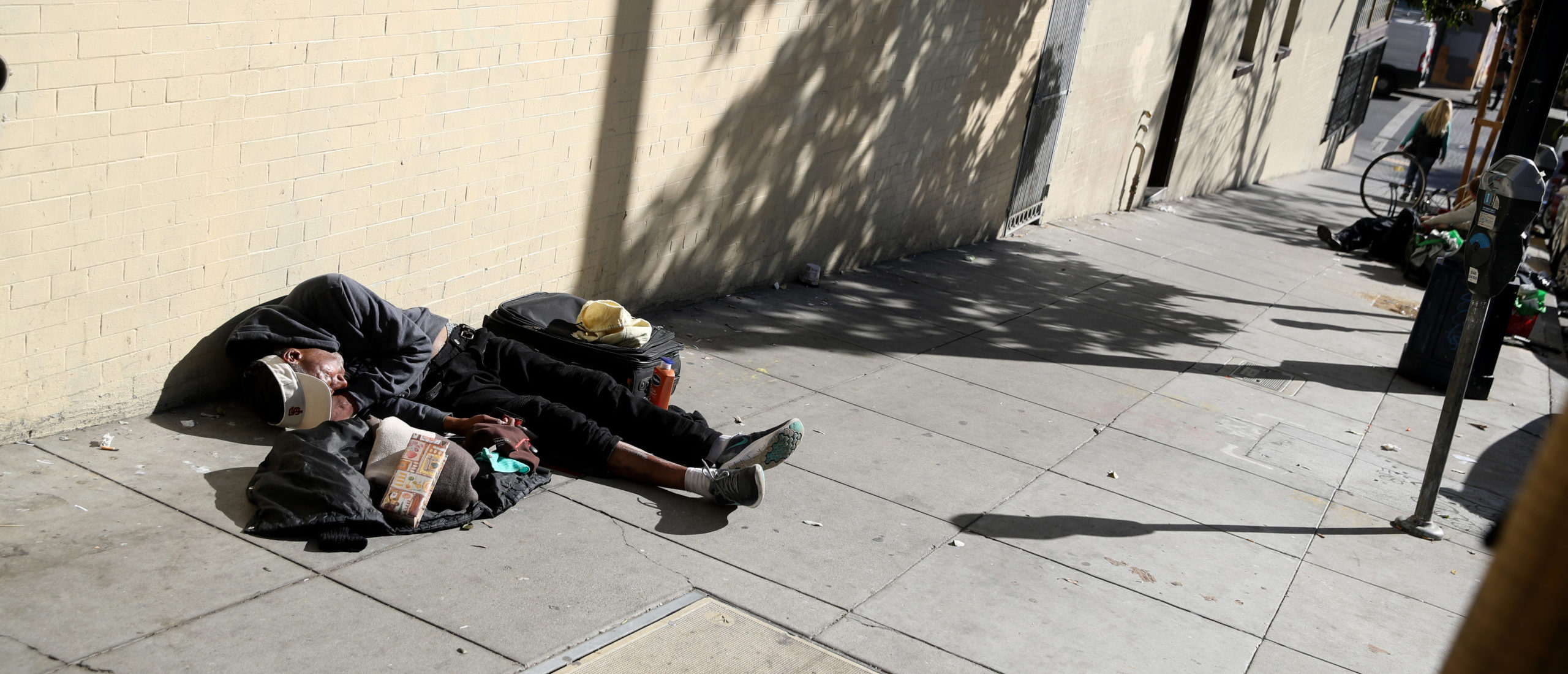 SAN FRANCISCO, CALIFORNIA - NOVEMBER 25: A homeless man sleeps on the sidewalk on November 25, 2019 in San Francisco, California. (Photo by Justin Sullivan/Getty Images)