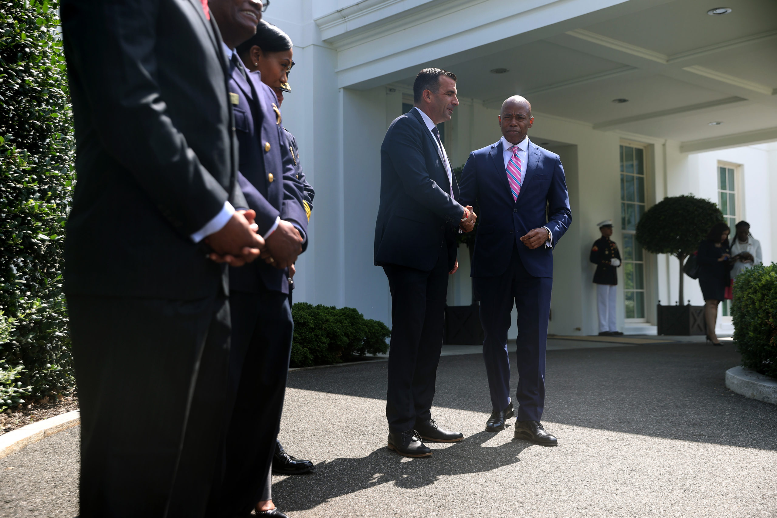 Brooklyn Borough President and New York City mayoral nominee Eric Adams (R) shakes hands with San Jose Mayor Sam Liccardo outside the West Wing following a meeting with U.S. President Joe Biden and U.S. Attorney General Merrick Garland about reducing gun violence at the White House on July 12, 2021 in Washington, DC. The meeting included law enforcement leaders, elected officials, and others. (Photo by Chip Somodevilla/Getty Images)