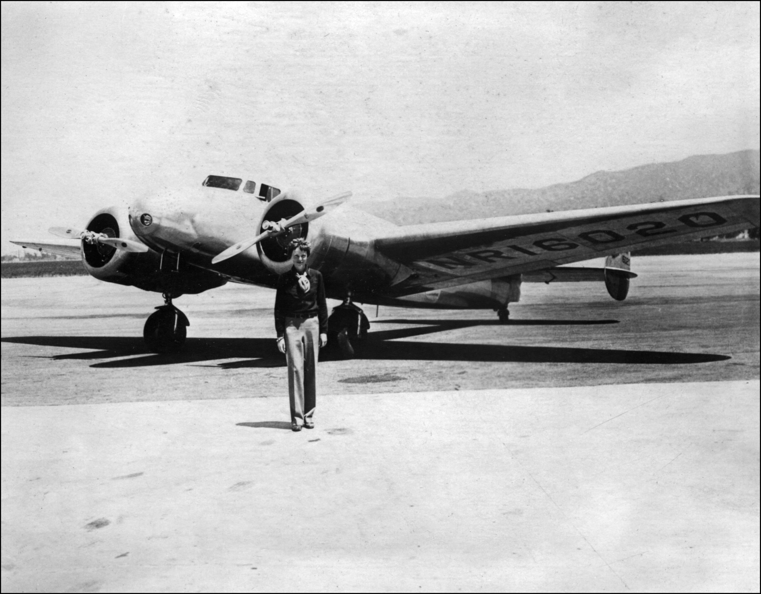 Amelia Earhart in front of her plane in undated picture