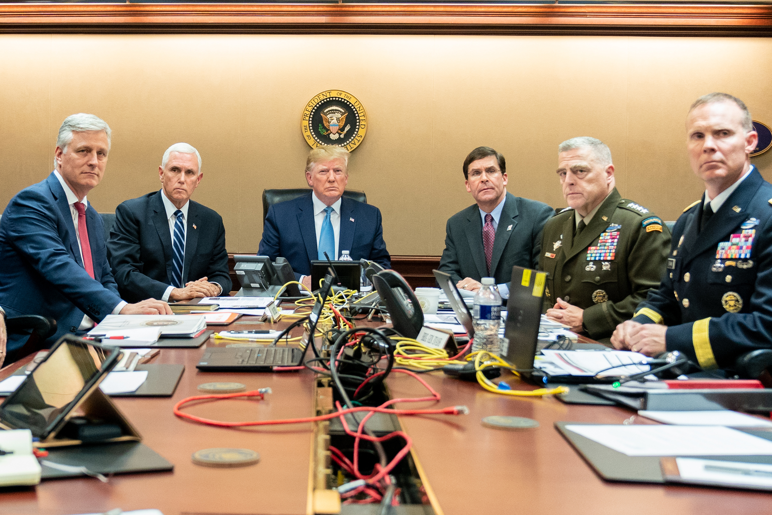 WASHINGTON, DC - OCTOBER 26: In this handout photo provided by the White House, President Donald J. Trump is joined by Vice President Mike Pence (2nd L), National Security Advisor Robert O’Brien (L), Secretary of Defense Mark Esper (3rd R), Chairman of the Joint Chiefs of Staff U.S. Army General Mark A. Milley (2nd R) and Brig. Gen. Marcus Evans, Deputy Director for Special Operations on the Joint Staff in the Situation Room of the White House October 26, 2019 in Washington, DC. The President was monitoring developments as U.S. Special Operations forces close in on ISIS leader Abu Bakr al-Baghdadi’s compound in Syria with a mission to kill or capture the terrorist.