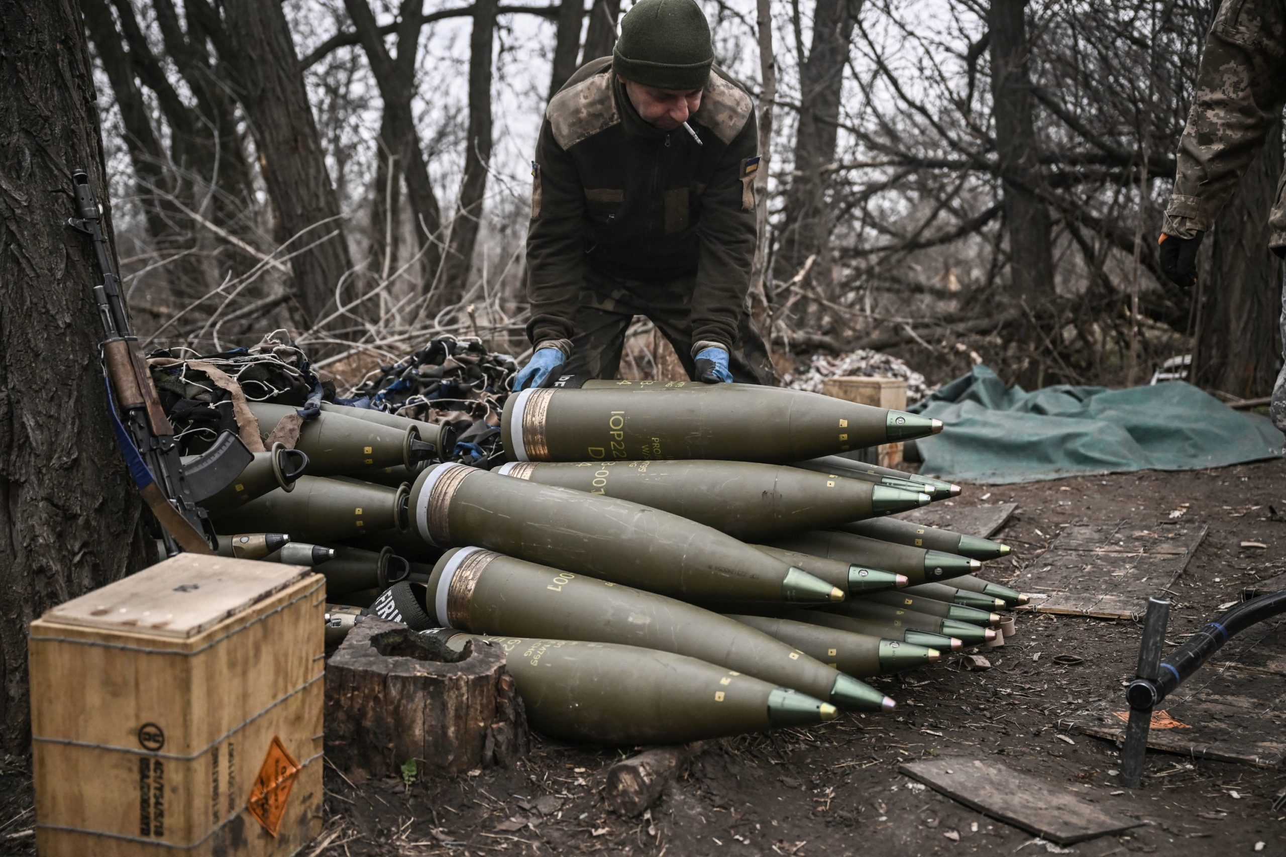A Ukrainian serviceman prepares 155mm artillery shells near Bakhmut, eastern Ukraine, on March 17, 2023, amid the Russian invasion of Ukraine. 