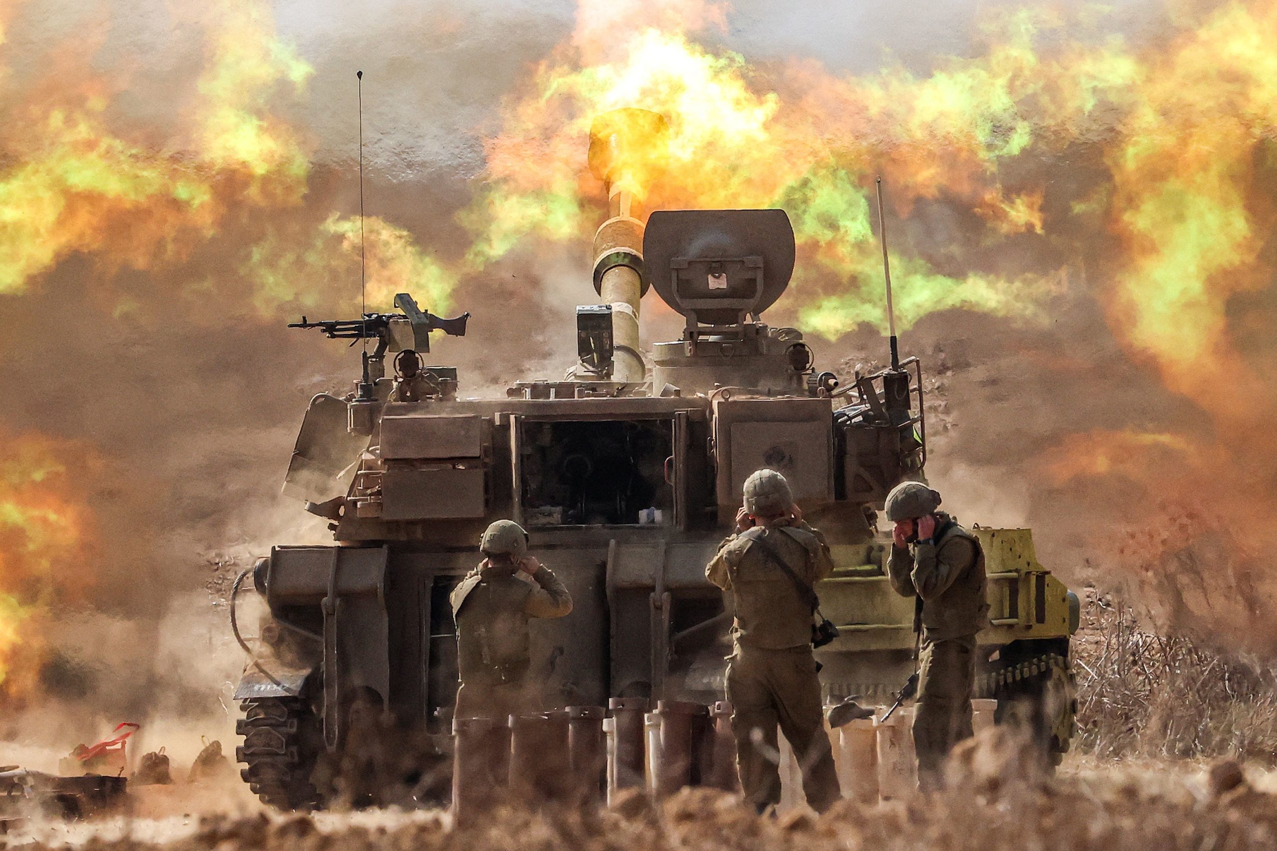 TOPSHOT - An Israeli army M109 155mm self-propelled howitzer fires rounds near the border with Gaza in southern Israel on October 11, 2023. Israel declared war on Hamas on October 8 following a shock land, air, and sea assault by the Gaza-based militant group. The death toll in Israel has surged above 1,200 following the worst attack in the country's 75-year history, while Gaza officials have reported 1000 people killed so far. 