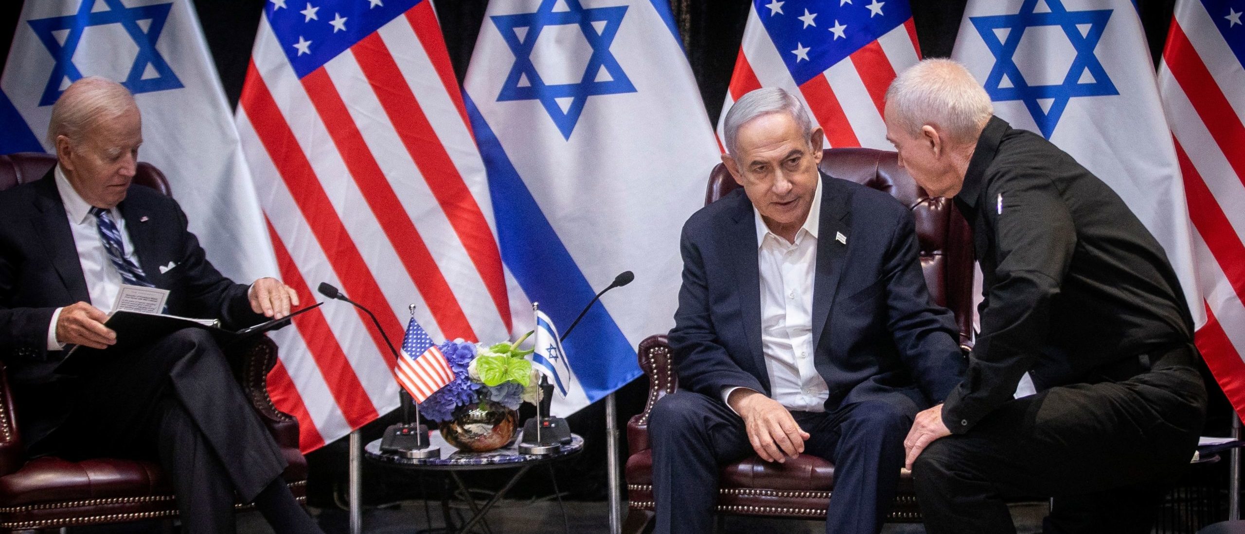 Israeli Prime Minister Benjamin Netanyahu (2nR), confers with Defense Minister Yoav Gallant (R), during their meeting with US President Joe Biden (L) at the start of the Israeli war cabinet meeting, in Tel Aviv on October 18, 2023, amid the ongoing battles between Israel and the Palestinian group Hamas. US President Joe Biden landed in Tel Aviv on October 18, 2023 as Middle East anger flared after hundreds were killed when a rocket struck a hospital in war-torn Gaza, with Israel and the Palestinians quick to trade blame. (Photo by Miriam Alster / POOL / AFP) (Photo by MIRIAM ALSTER/POOL/AFP via Getty Images)