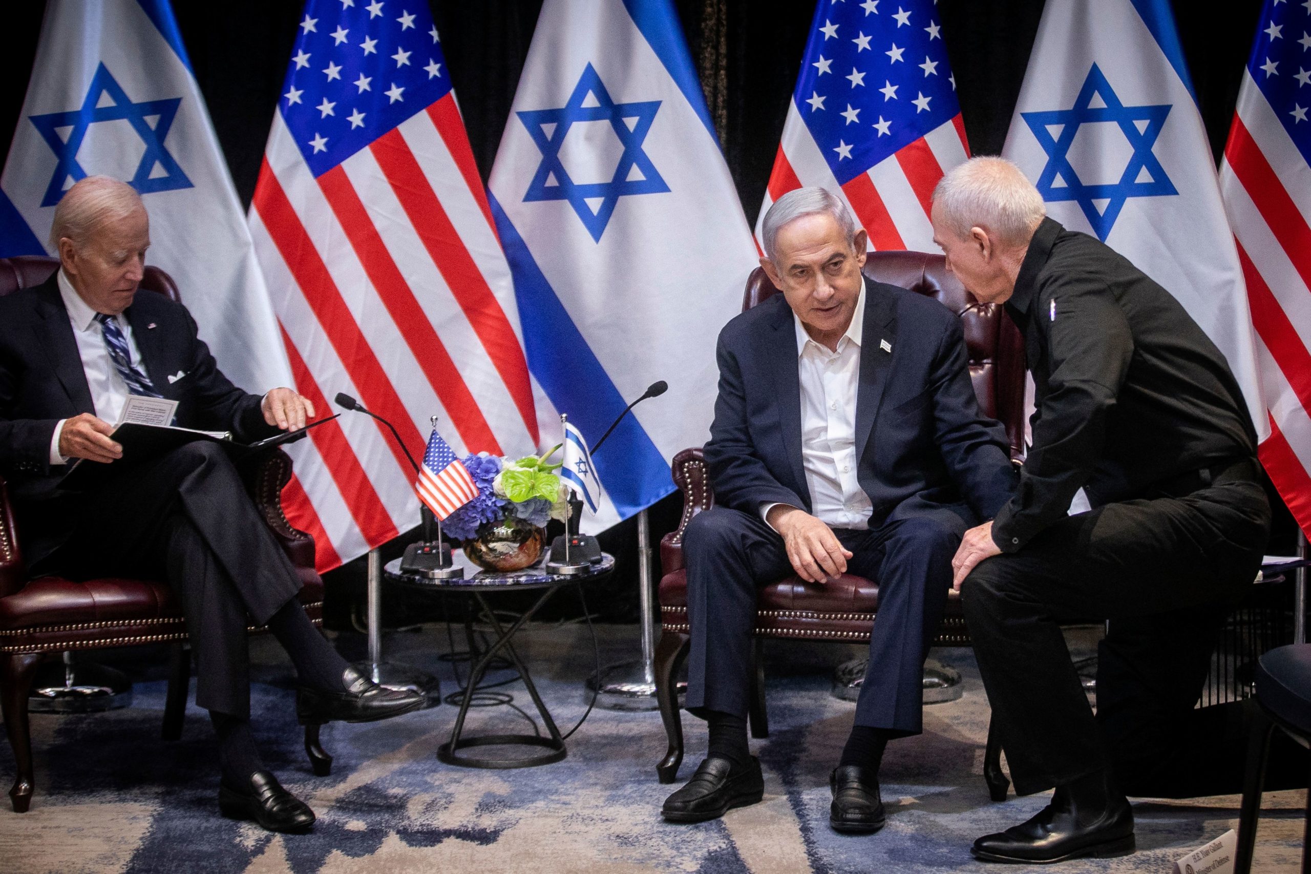 Israeli Prime Minister Benjamin Netanyahu (2nR), confers with Defense Minister Yoav Gallant (R), during their meeting with US President Joe Biden (L) at the start of the Israeli war cabinet meeting, in Tel Aviv on October 18, 2023, amid the ongoing battles between Israel and the Palestinian group Hamas. US President Joe Biden landed in Tel Aviv on October 18, 2023 as Middle East anger flared after hundreds were killed when a rocket struck a hospital in war-torn Gaza, with Israel and the Palestinians quick to trade blame. (Photo by Miriam Alster / POOL / AFP) (Photo by MIRIAM ALSTER/POOL/AFP via Getty Images)
