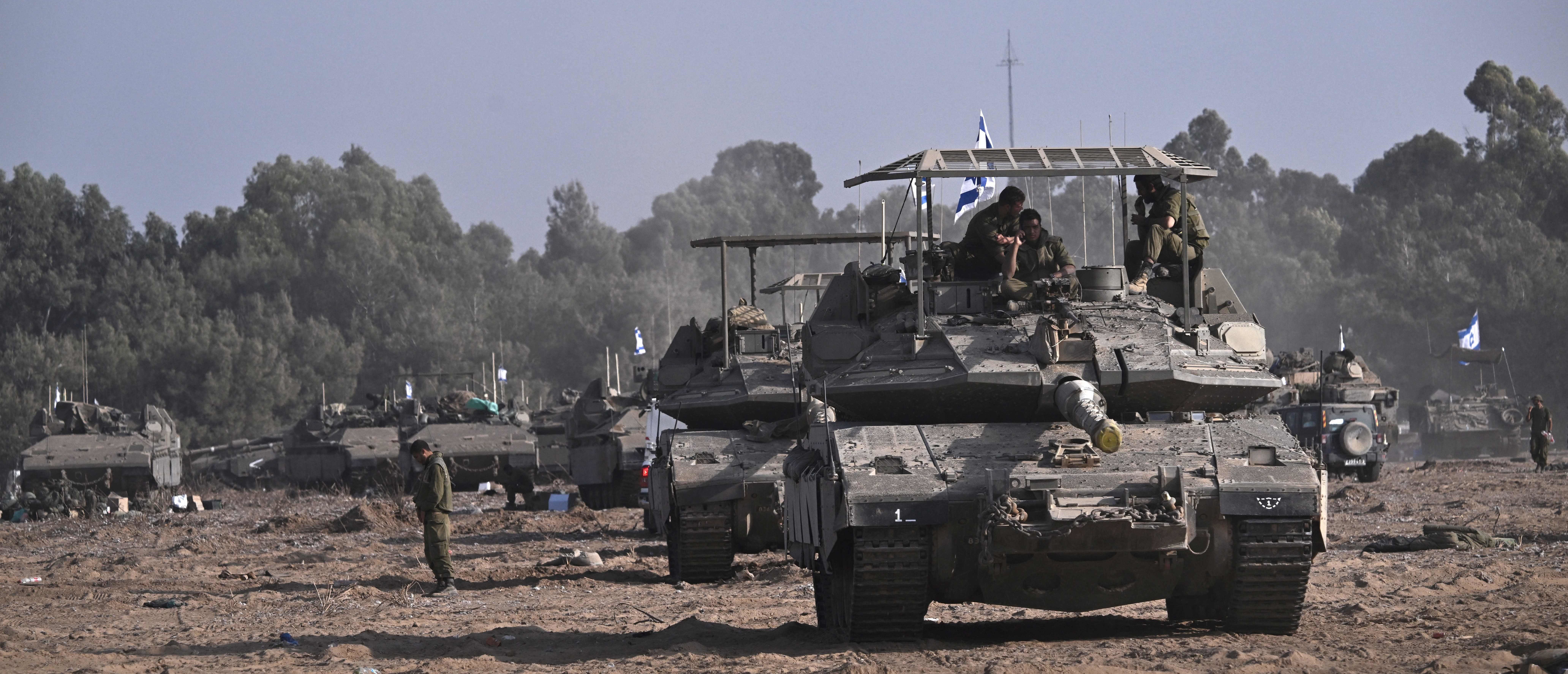 Israeli military armoured vehicles and tanks deploy along Israel's border with Gaza on October 24, 2023, amid the ongoing battles between Israel and the Palestinian group Hamas. Thousands of civilians, both Palestinians and Israelis, have died since October 7, 2023, after Palestinian Hamas militants based in the Gaza Strip entered southern Israel in an unprecedented attack triggering a war declared by Israel on Hamas with retaliatory bombings on Gaza.