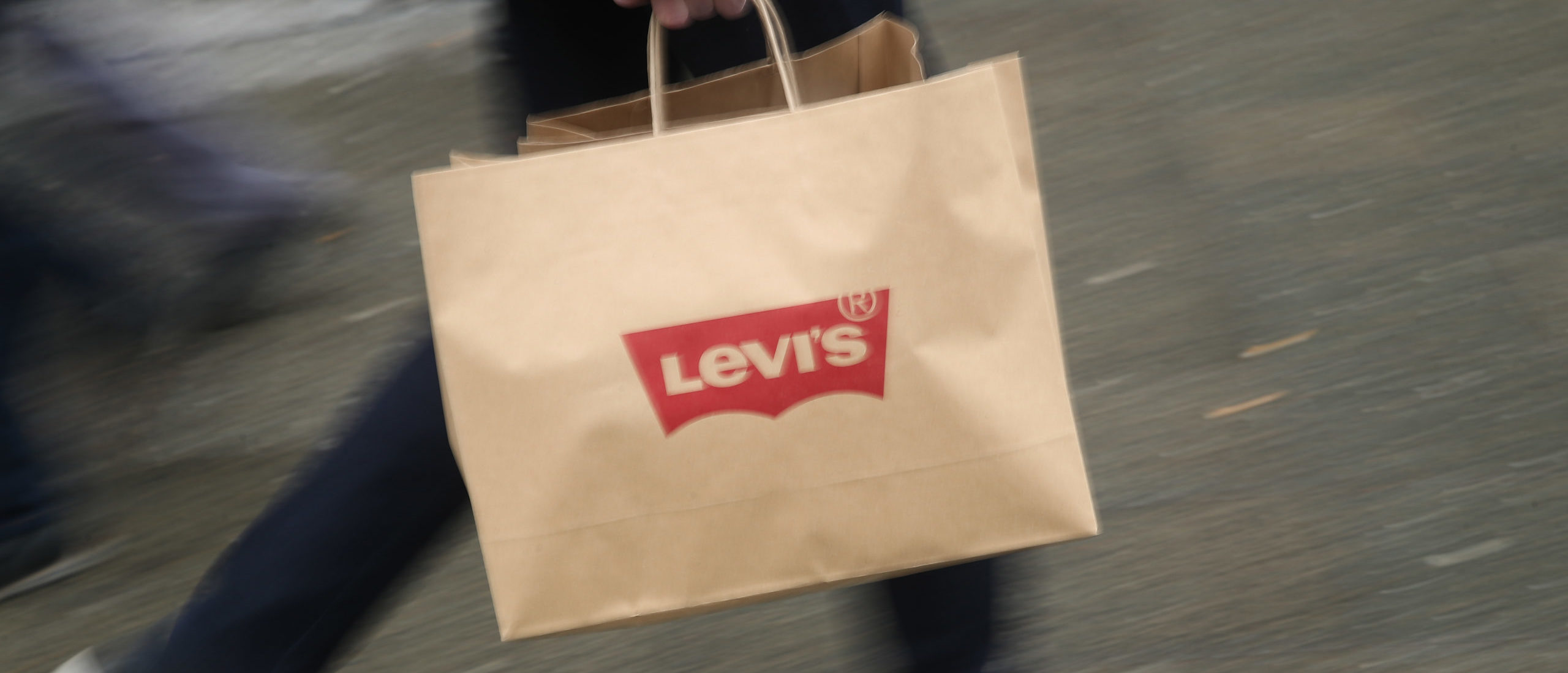 BERLIN, GERMANY - MARCH 05: PA man carries a shopping bag from a Levi's jeans and clothing store on March 5, 2018 in Berlin, Germany. Tensions between U.S. President Donald Trump and the European Union are rising after Trump announced he would respond to any E.U. tariffs on American goods with U.S. tariffs on European cars. Trump originally sought tariffs on imports of steel and aluminum, to which EU officials said they would respond with tariffs on U.S. bourbon, Levi's jeans and Harley-Davidson motorcycles. The European Union and Canada are the two biggest exporters of steel to the United States. (Photo by Sean Gallup/Getty Images)