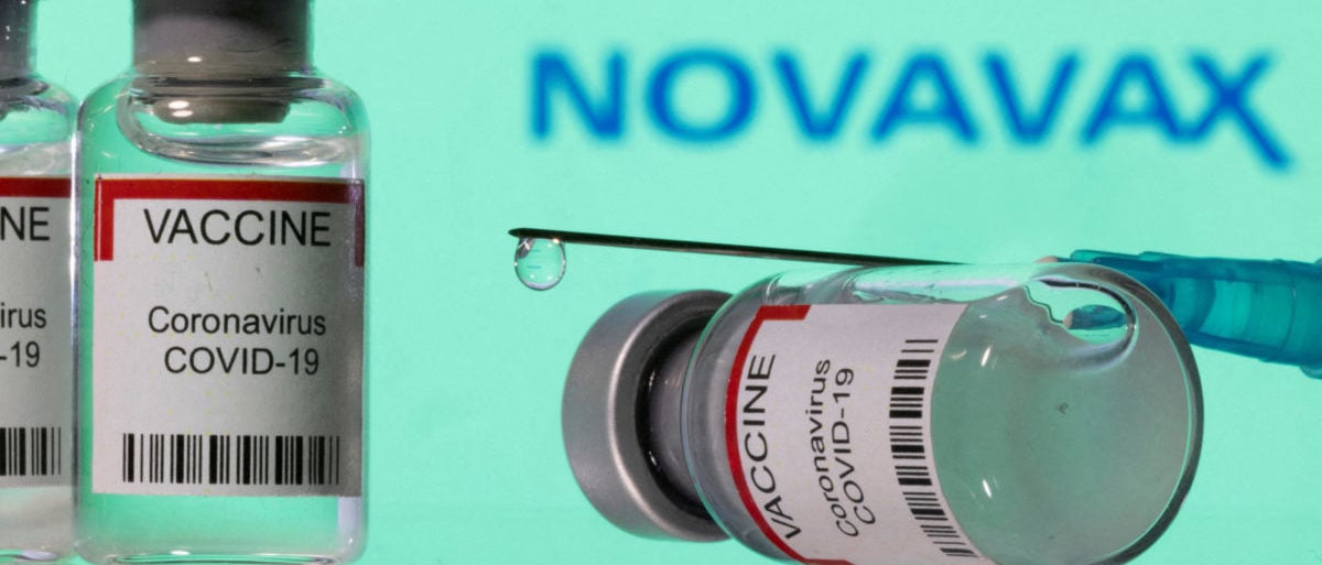 FILE PHOTO: Vials labelled "VACCINE Coronavirus COVID-19" and a syringe are seen in front of a displayed Novavax logo in this illustration taken December 11, 2021. REUTERS/Dado Ruvic/Illustration/File Photo