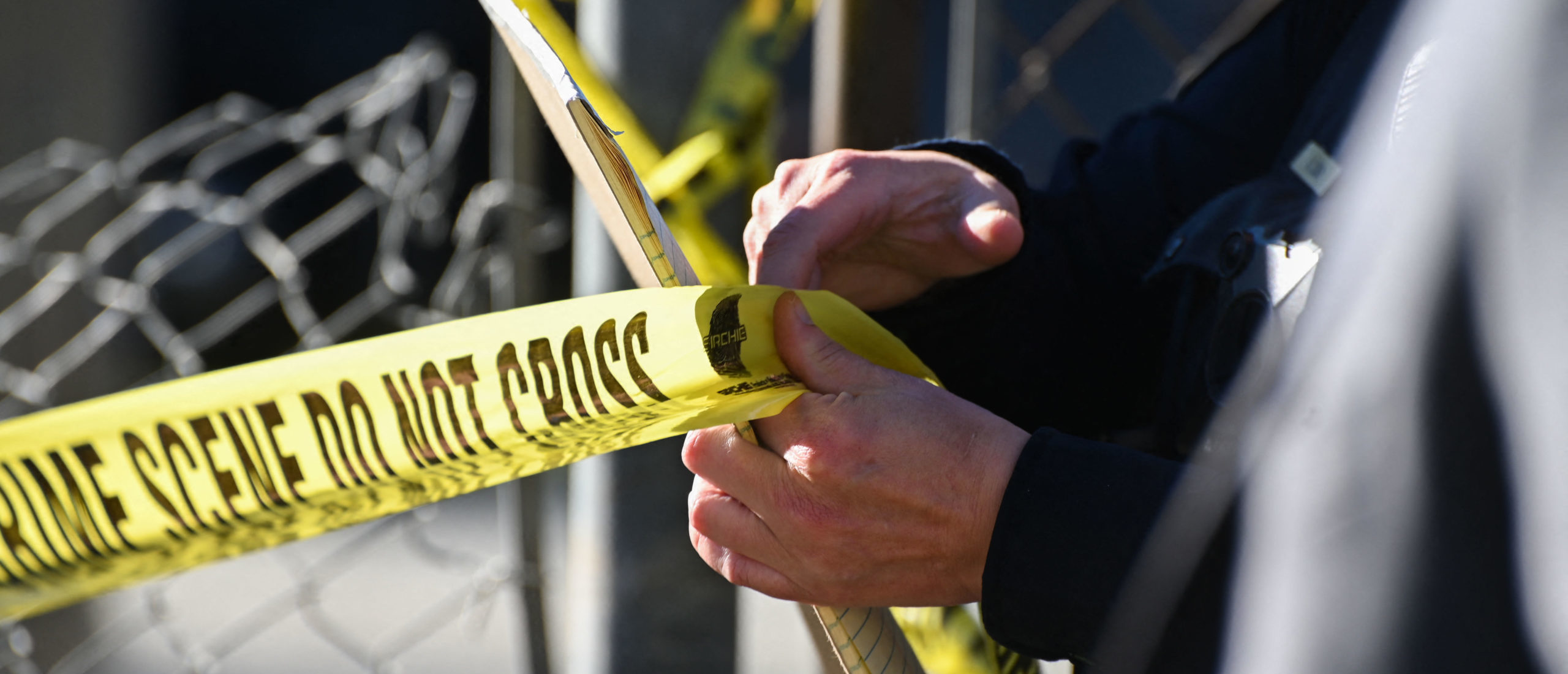 A San Mateo County Sheriff officer puts up police tape at a crime scene after a shooting at the Spanish Town shops in Half Moon Bay, California, on January 24, 2023. - A suspected gunman was in custody Monday over the killing of seven people in a rural community in northern California, just two days after a mass shooting at a Lunar New Year celebration near Los Angeles. Police line do not cross (Photo by SAMANTHA LAUREY/AFP via Getty Images)