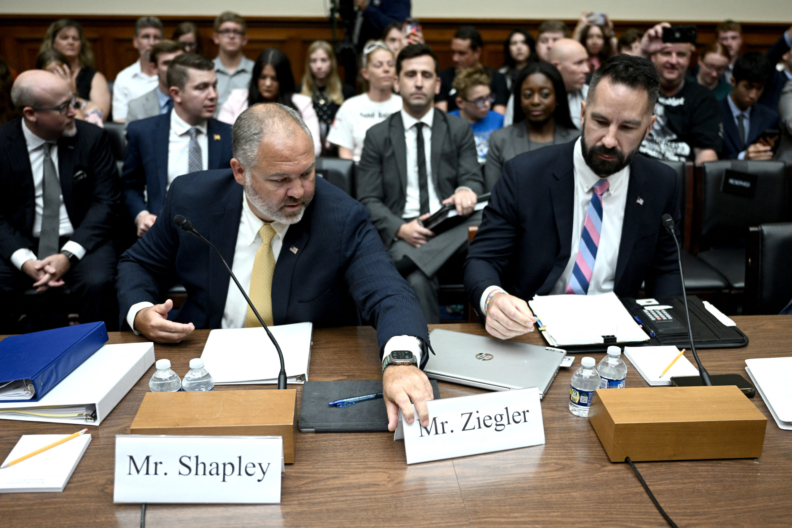 Gary Shapley (L), Supervisory Special Agent at the Internal Revenue Service, adjusts the nametags as he and Joe Ziegler, Internal Revenue Service (IRS) Whistleblower X, arrive to testify before the House Committee on Oversight and Accountability during a hearing regarding the criminal investigation into the Bidens, on Capitol Hill in Washington, DC, on July 19, 2023. (Photo by Brendan SMIALOWSKI / AFP) (Photo by BRENDAN SMIALOWSKI/AFP via Getty Images)