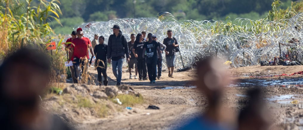 EAGLE PASS, TEXAS - SEPTEMBER 28: Immigrants walk towards a U.S. Border Patrol checkpoint after crossing the U.S.-Mexico border on September 28, 2023 in Eagle Pass, Texas. A surge of asylum seeking migrants crossing the U.S. southern border has put pressure on U.S. immigration authorities, reaching record levels in recent weeks. (Photo by John Moore/Getty Images)